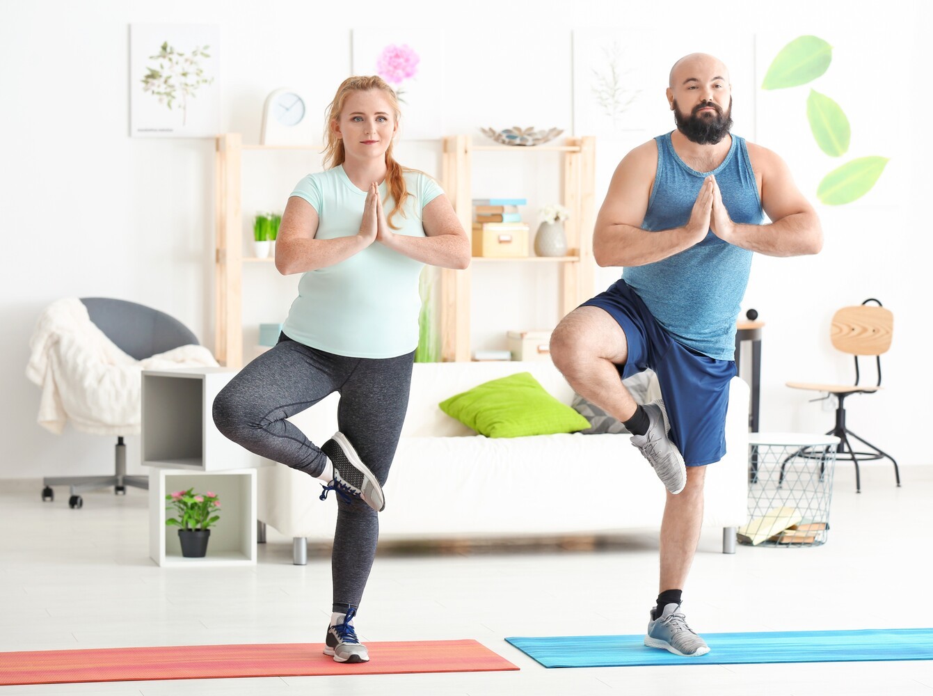 couple doing yoga positions for weight loss at home during a couple’s workout