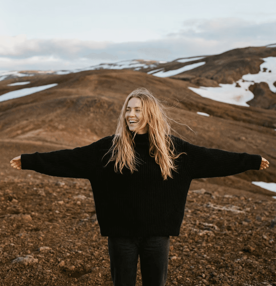 person sitting on the mountain cliff