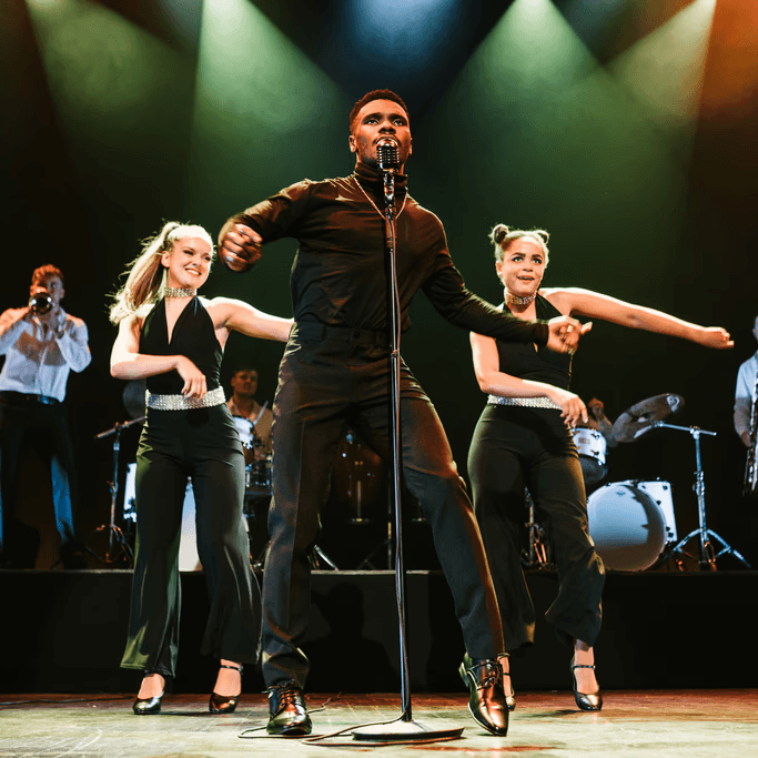 Live touring show performance with band and choreography