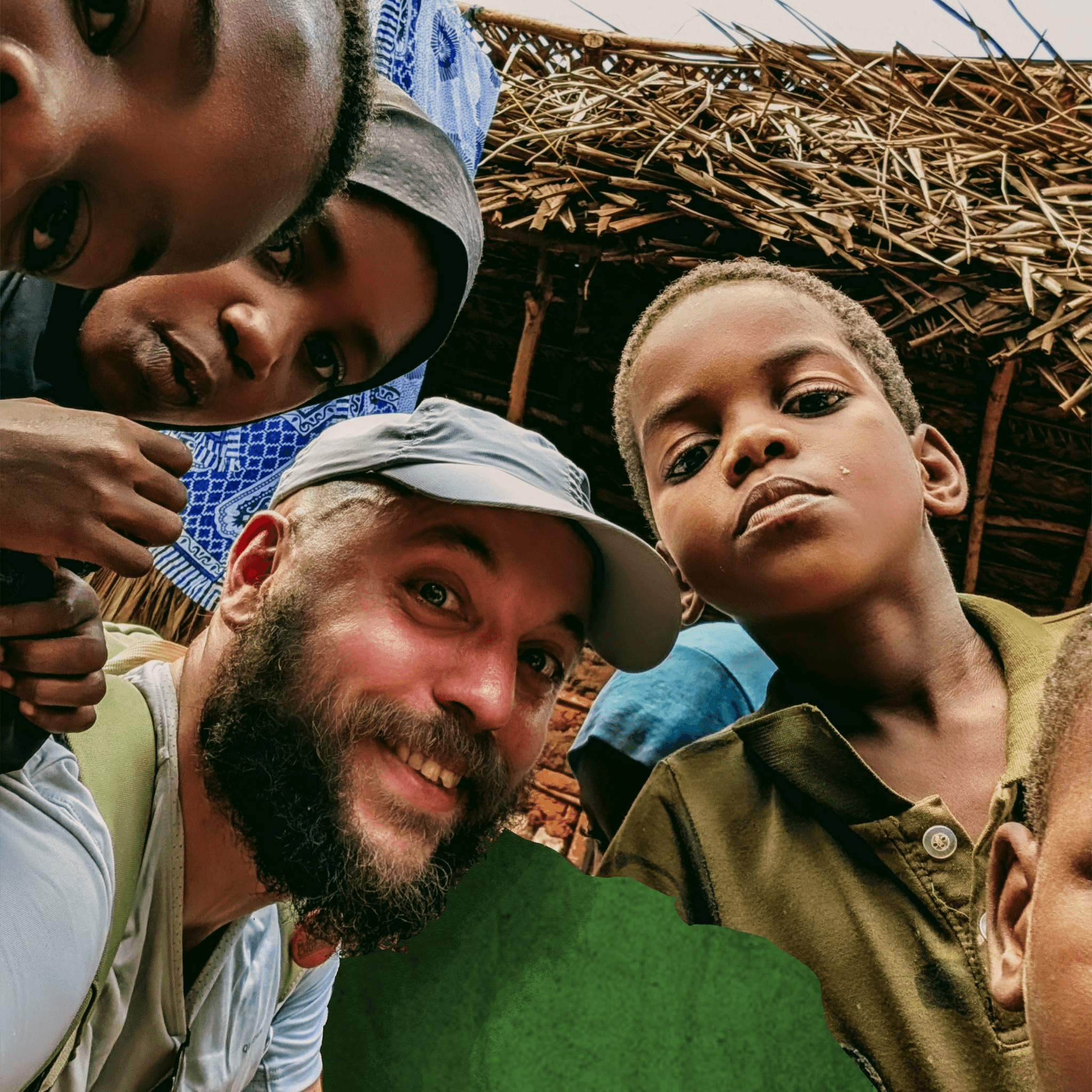 Traveler sitting on desert rocks during the Desert Sky tour in AlUla, smiling and holding binoculars.