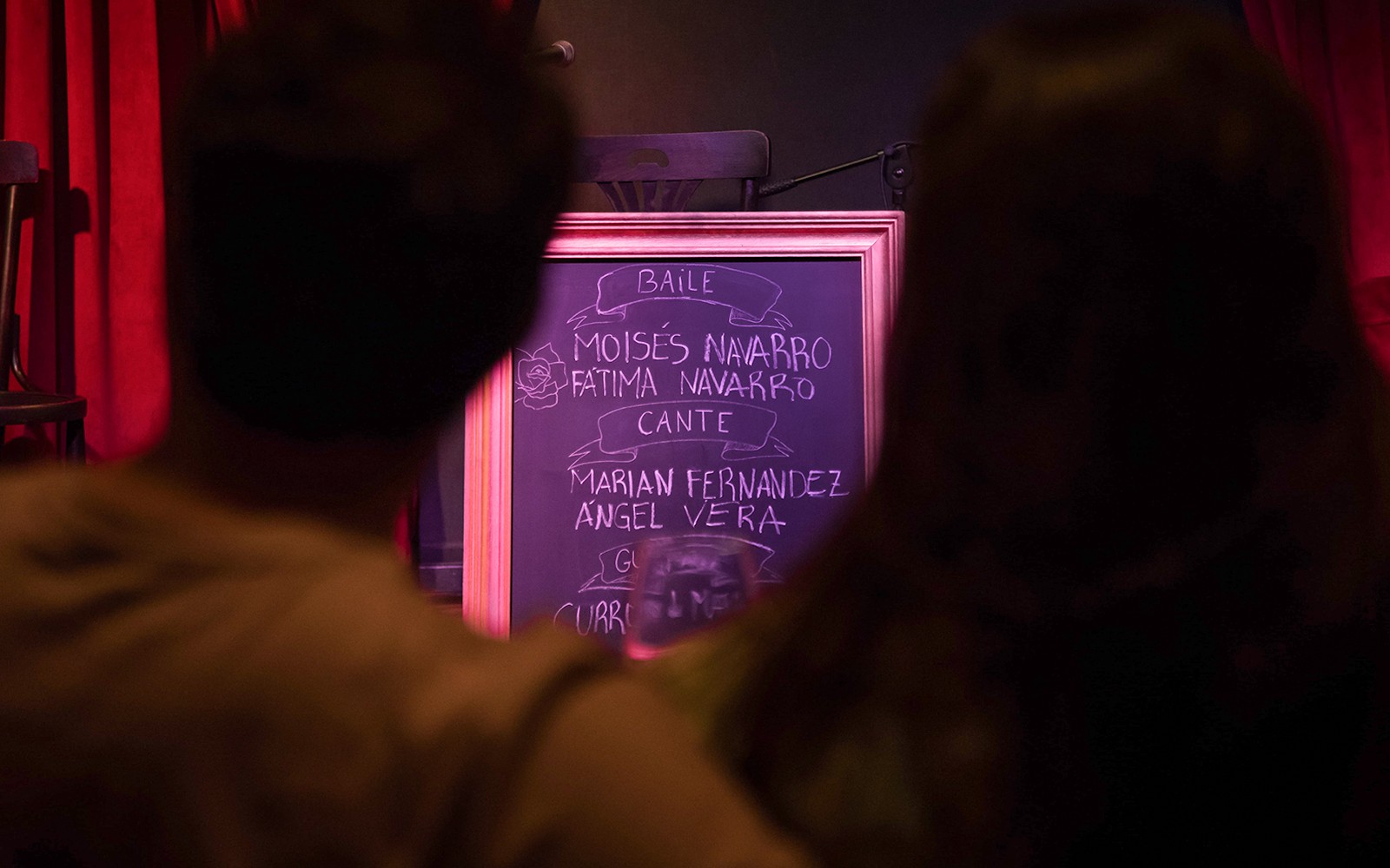 Chalkboard listing performers at Alegría Flamenco & Gastronomia event.