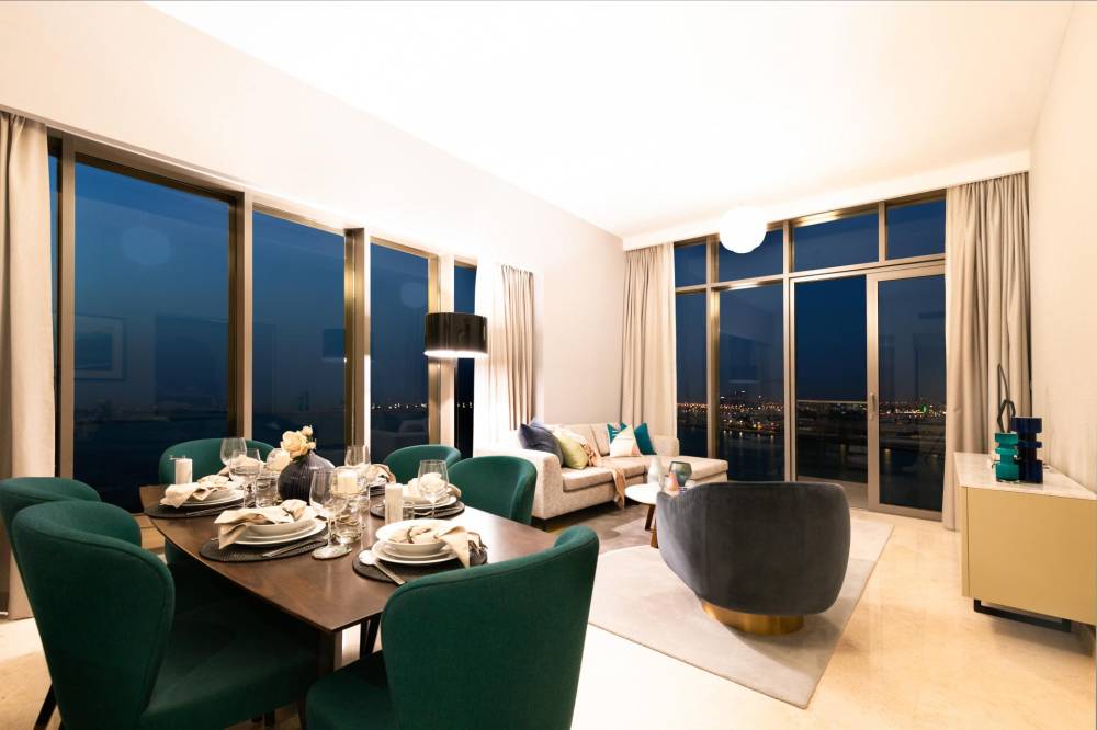  modern living room featuring a large window, showcasing natural light and contemporary furnishings in Anwa Omniyat Maritime City.
