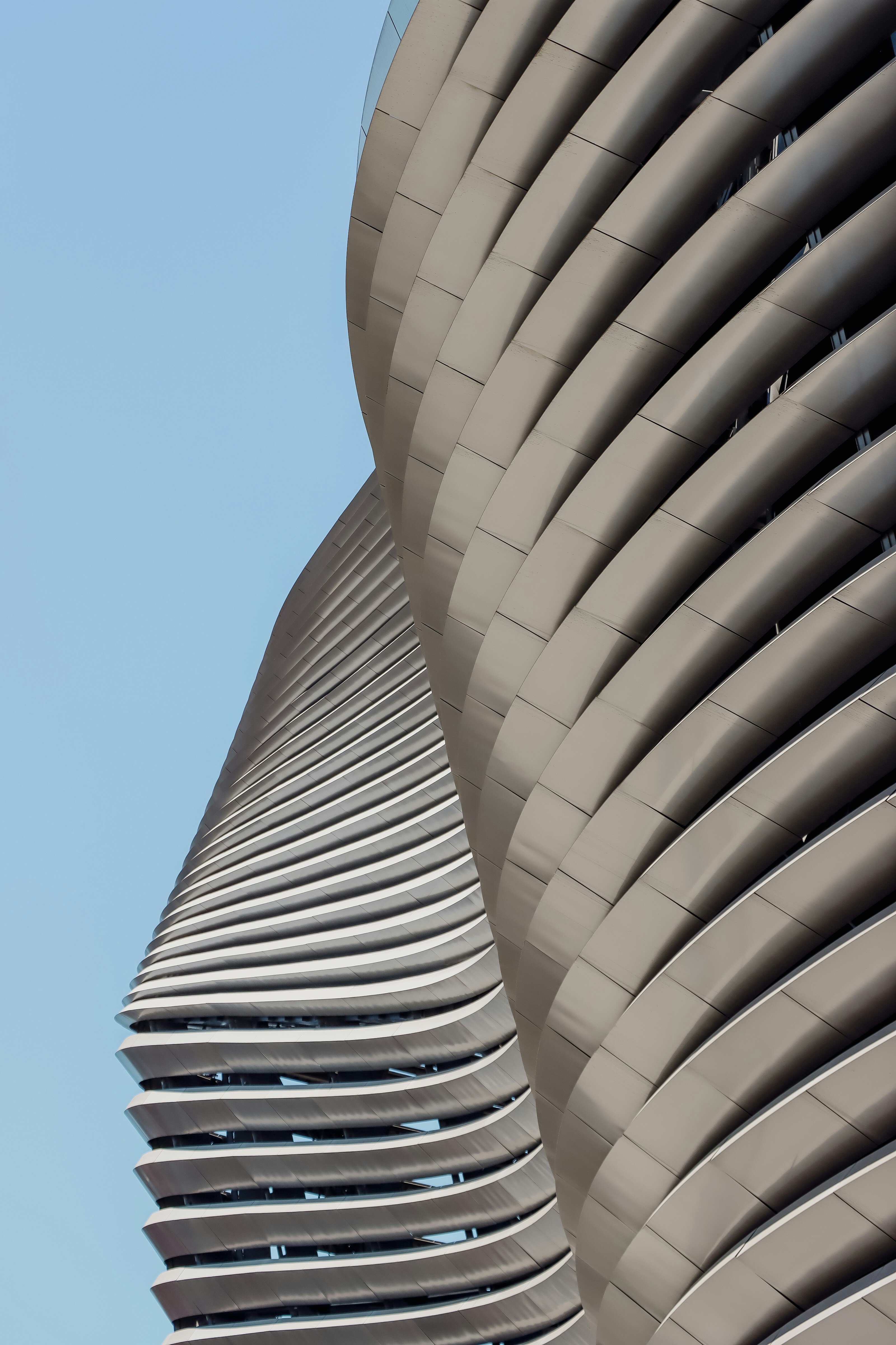 Modern buildings with wavy facade against blue sky