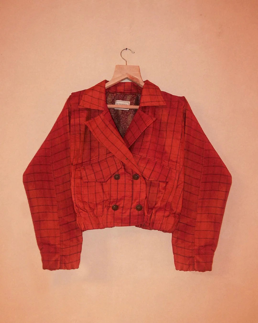 AMBR is our one-of-a-kind cropped two-toned silk brocade&nbsp; bomber jacket, handcrafted by skilled artisans in-house using a vintage silk saris. The back panel features a rich brocade. In our effort to use what already exists, both layers are crafted entirely from vintage textiles. With an exaggerated collar, a slight cinch at the waist, and antique buttons, Ambr stands as a tribute to local craftsmanship and mindful creation.