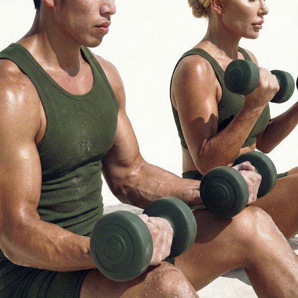 an and woman using dumbbells for weighted lunges at a fully equipped boutique HIIT studio in Lisbon