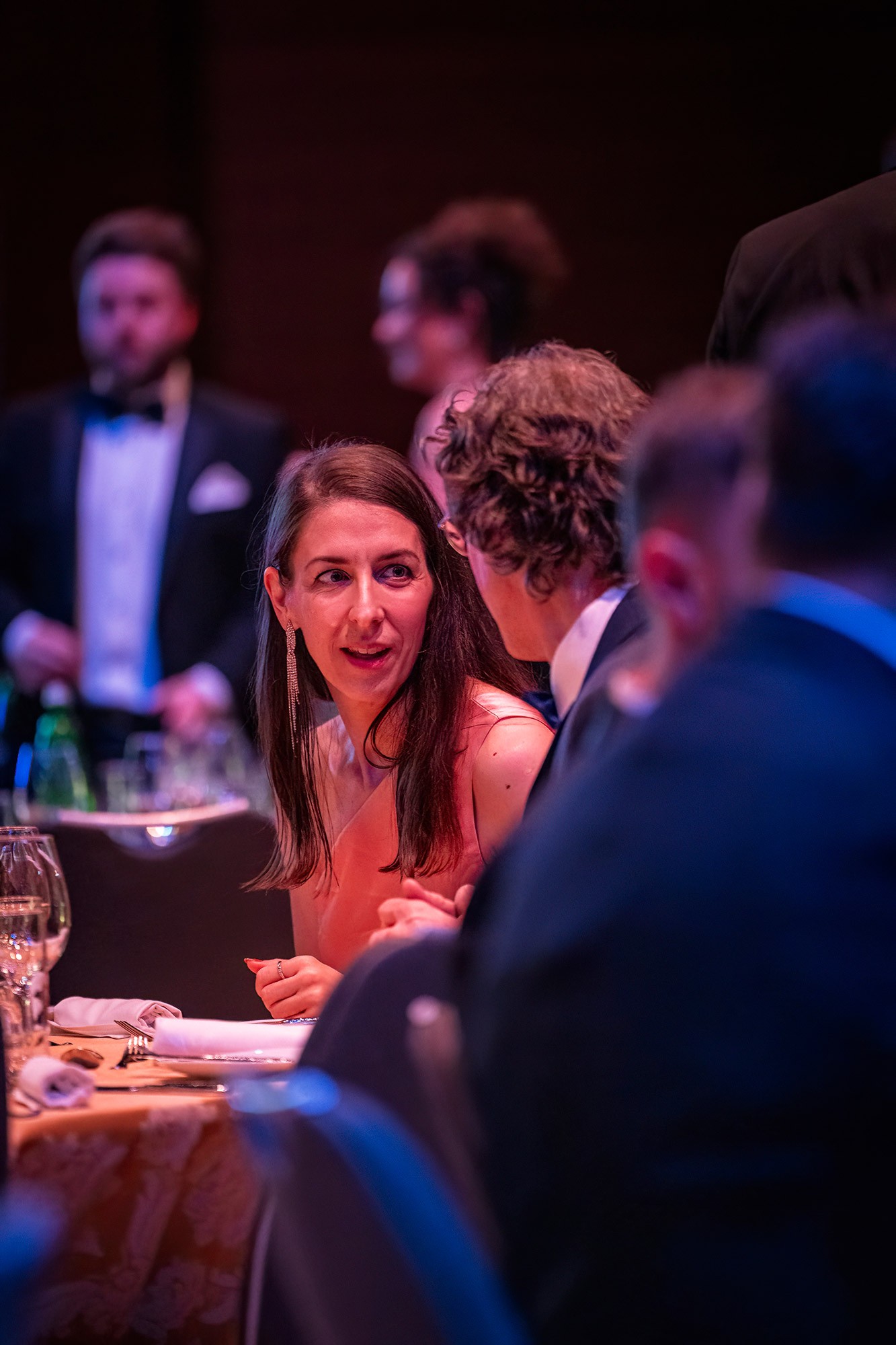 Corporate attendees in formal attire conversing at a gala dinner during the CWS international sales conference in Prague.