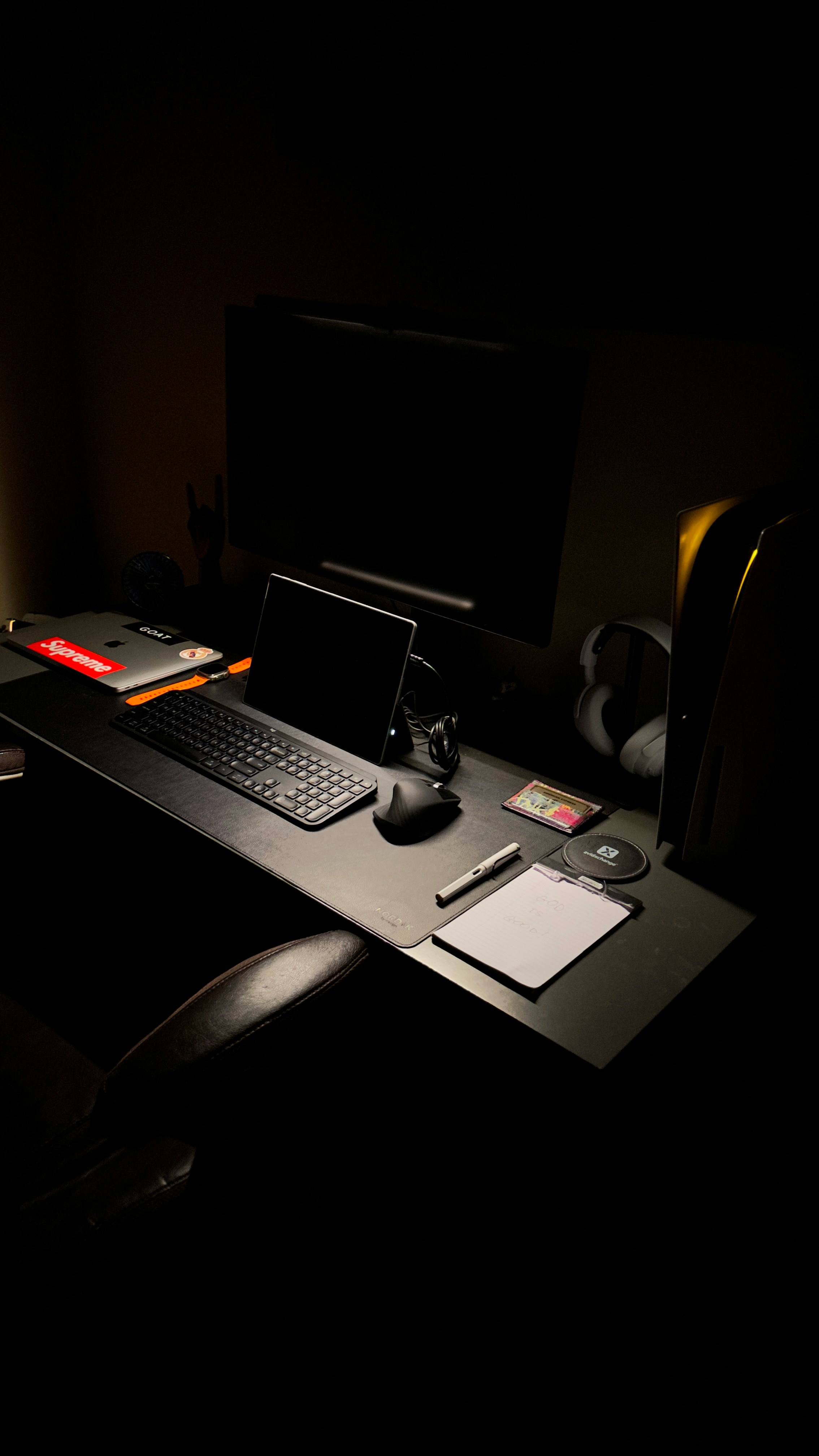 a desk with a laptop, keyboard, mouse and a monitor