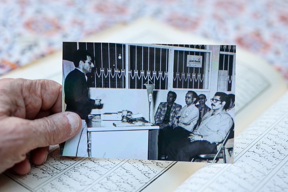 Bubjan with book and speaking to camera