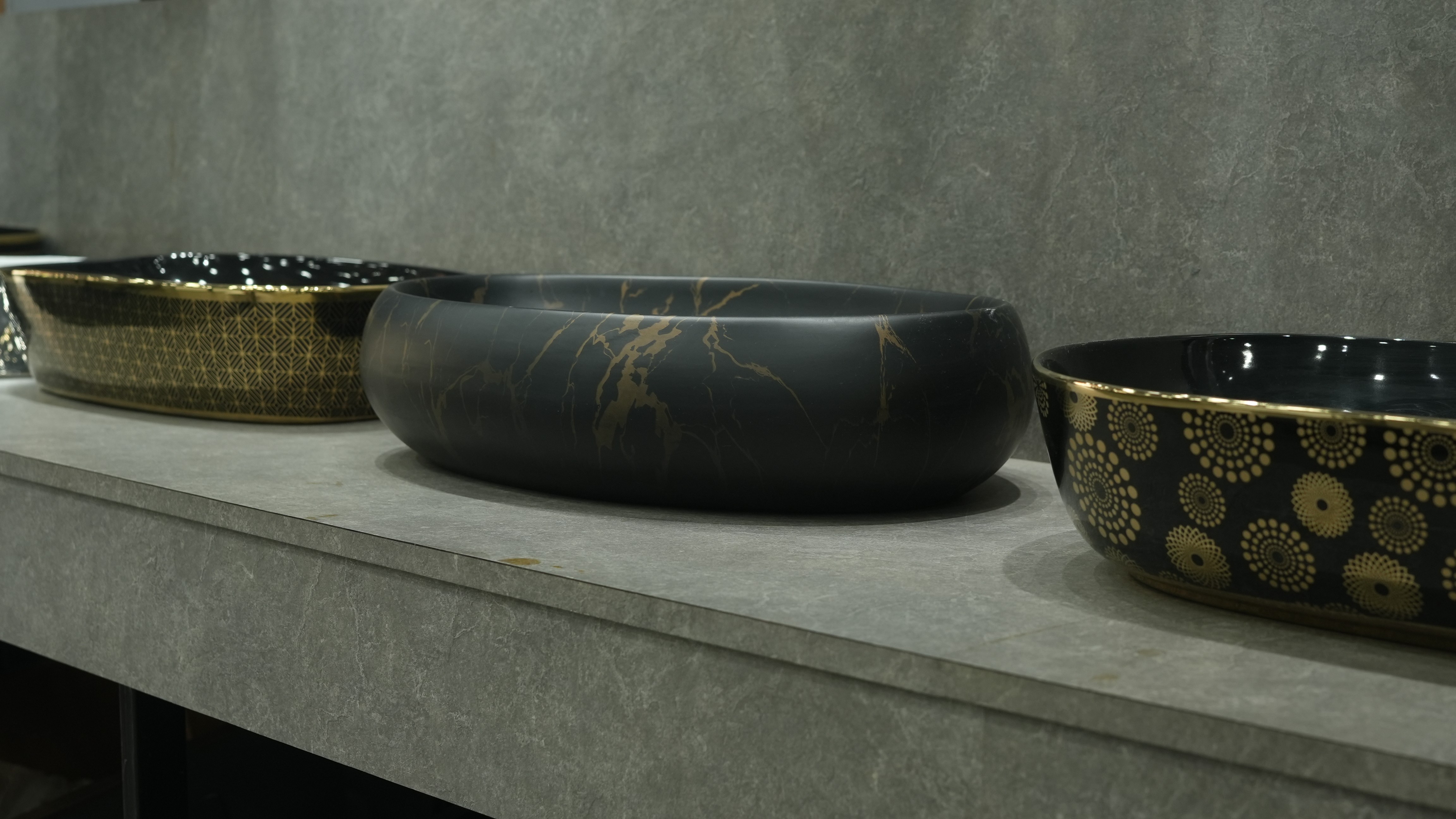 Modern living room with abstract art, beige sectional sofa, indoor plants, and large windows.