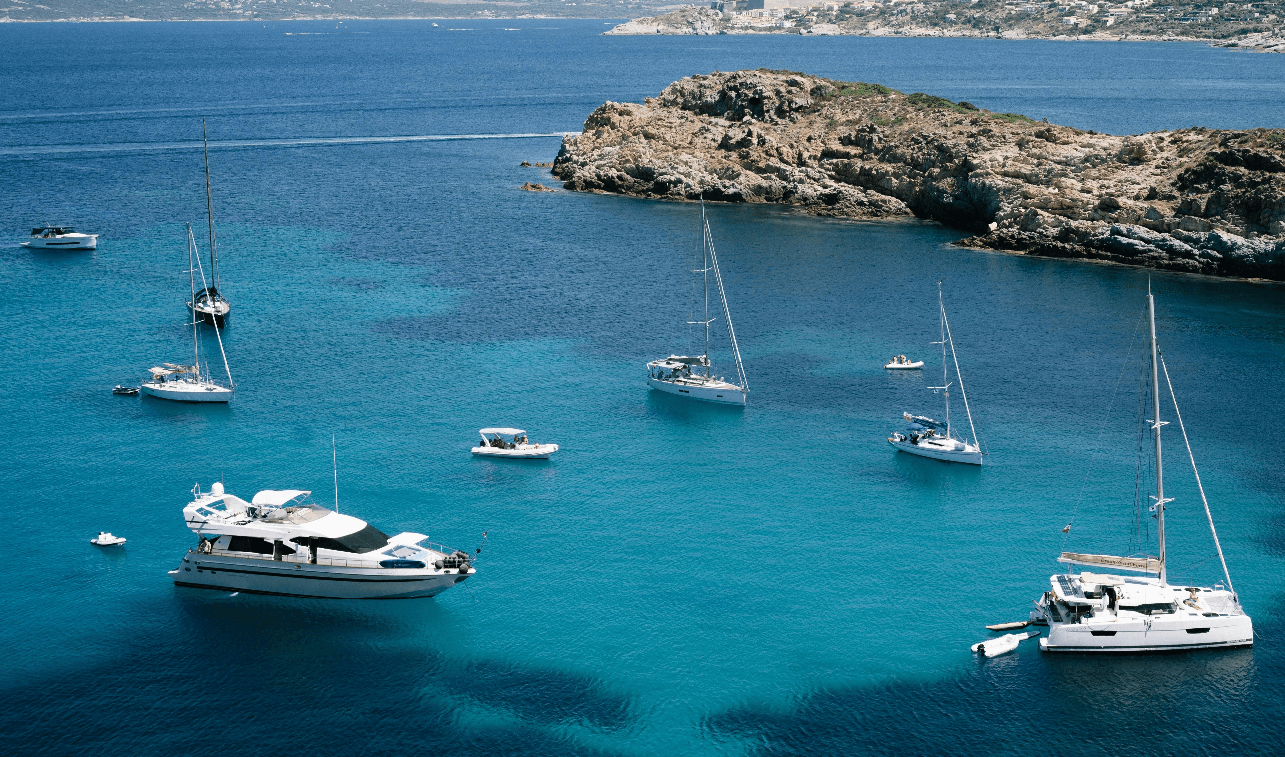 a sailboat in the water near a small island