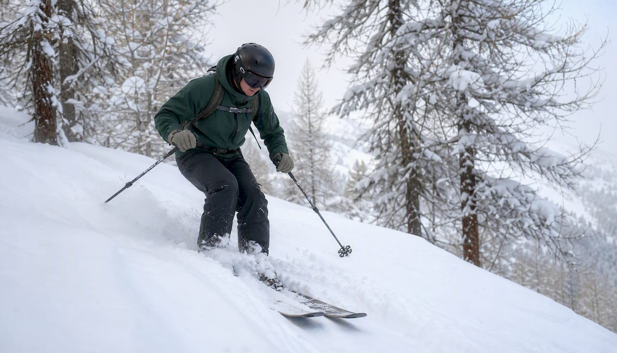 Side view of a skier maintaining a centred stance in deep snow