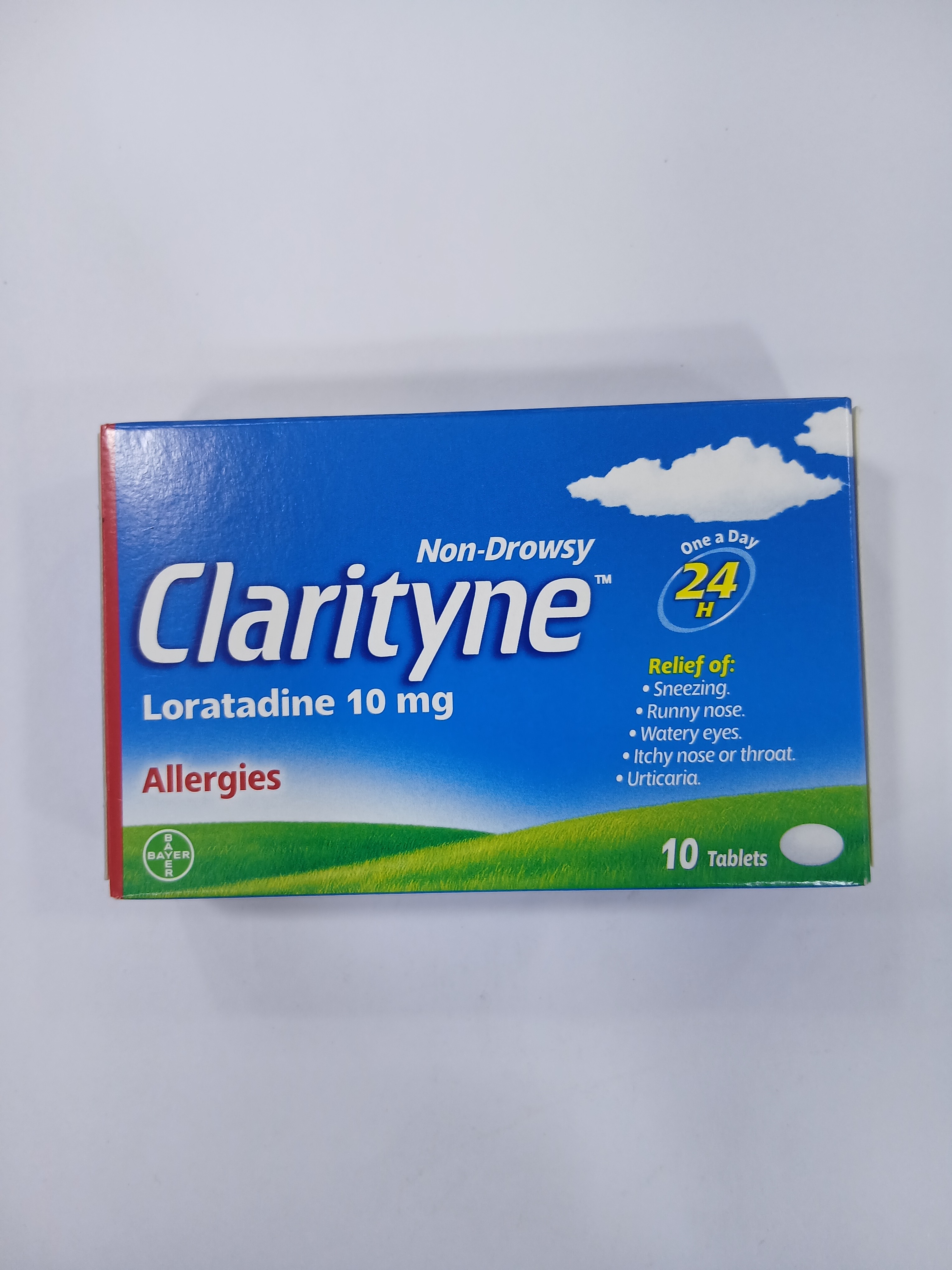 White cardboard box packaging displays a blue and green label with text indicating a non-drowsy allergy medication containing ten 10 mg loratadine tablets.
