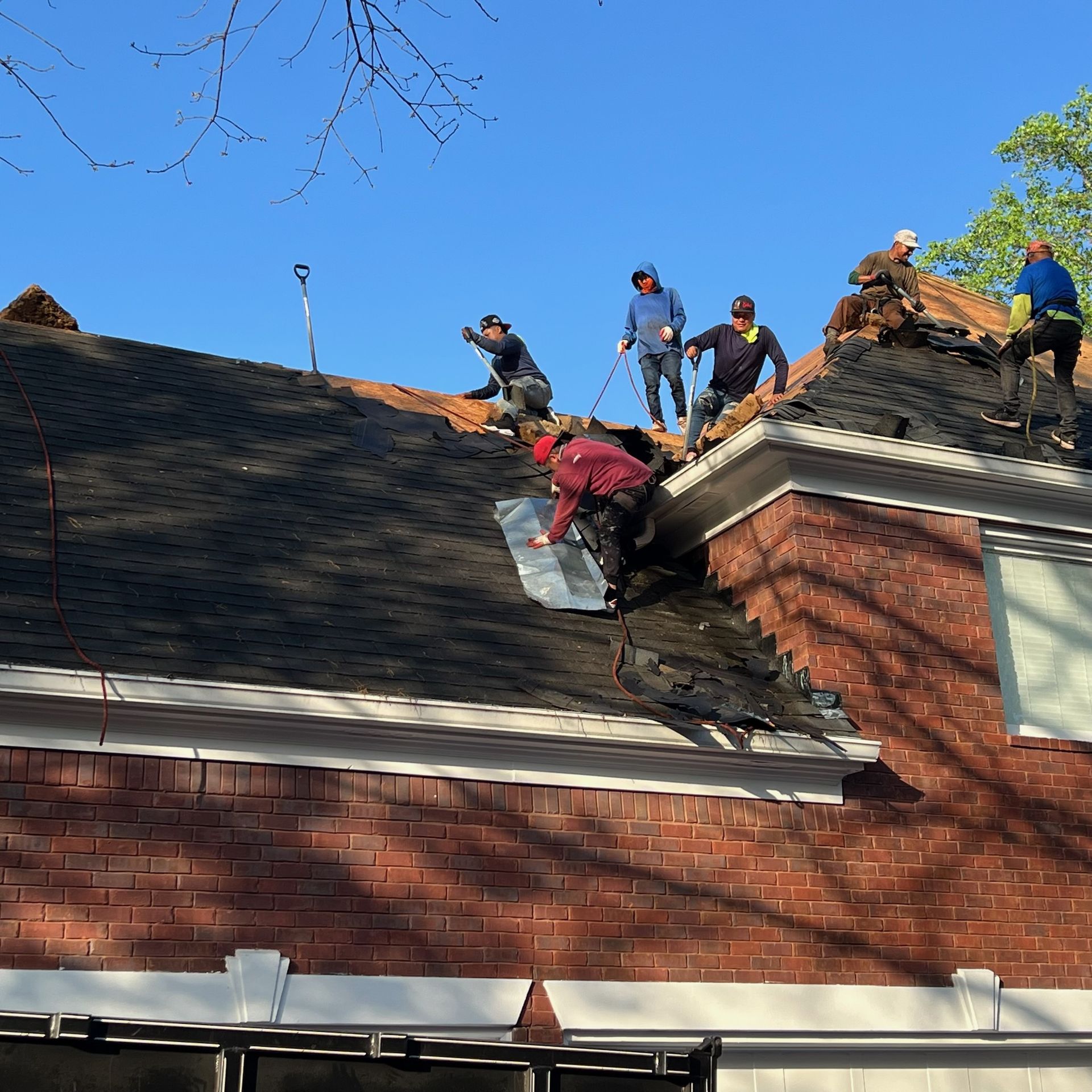 Tear-off starting at sunrise on a roof replacement in Alpharetta, GA