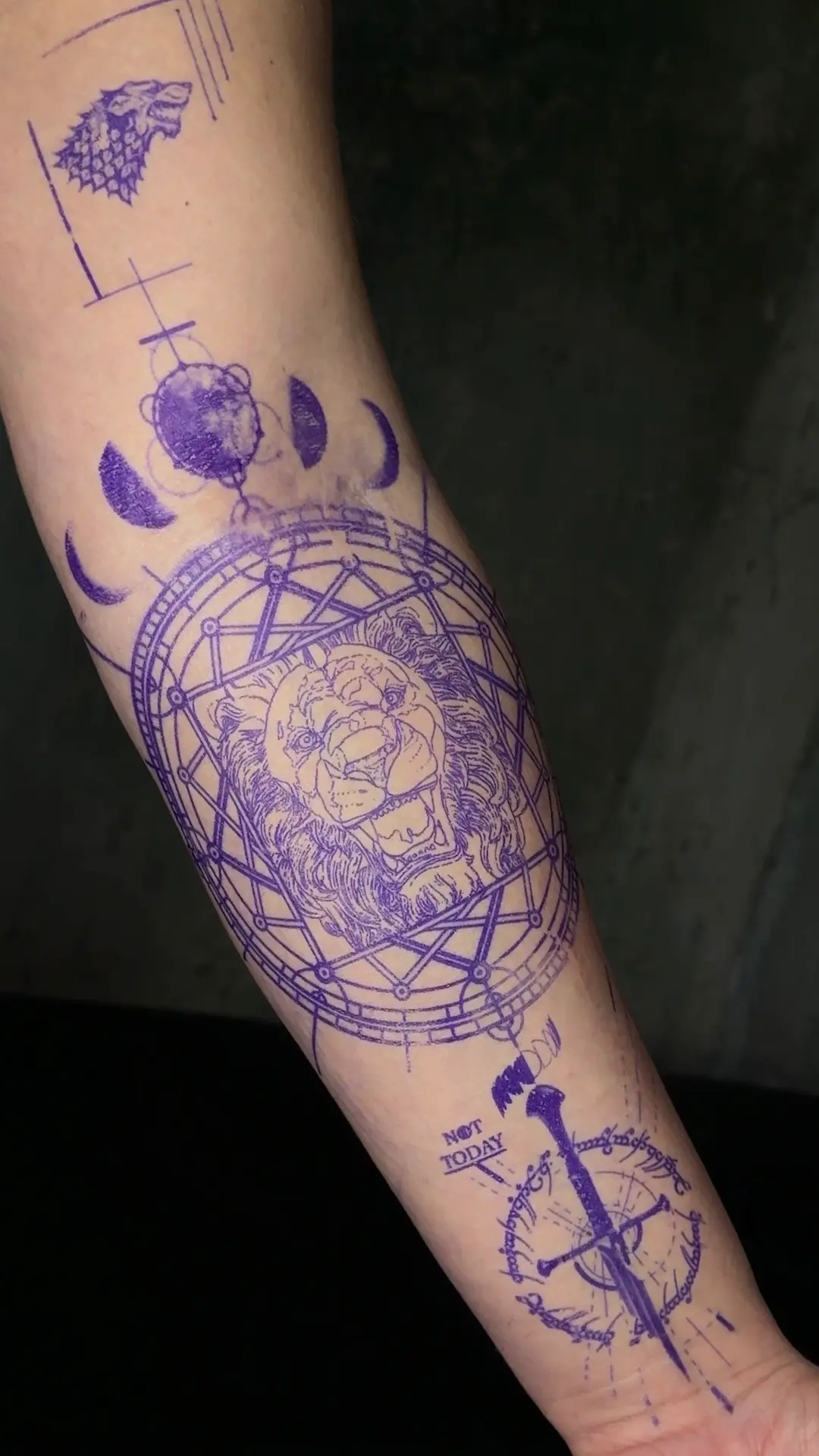 Precision placement of a custom geometric lion tattoo stencil on the forearm, demonstrating perfect anatomical flow and fine-line preparation before the session.