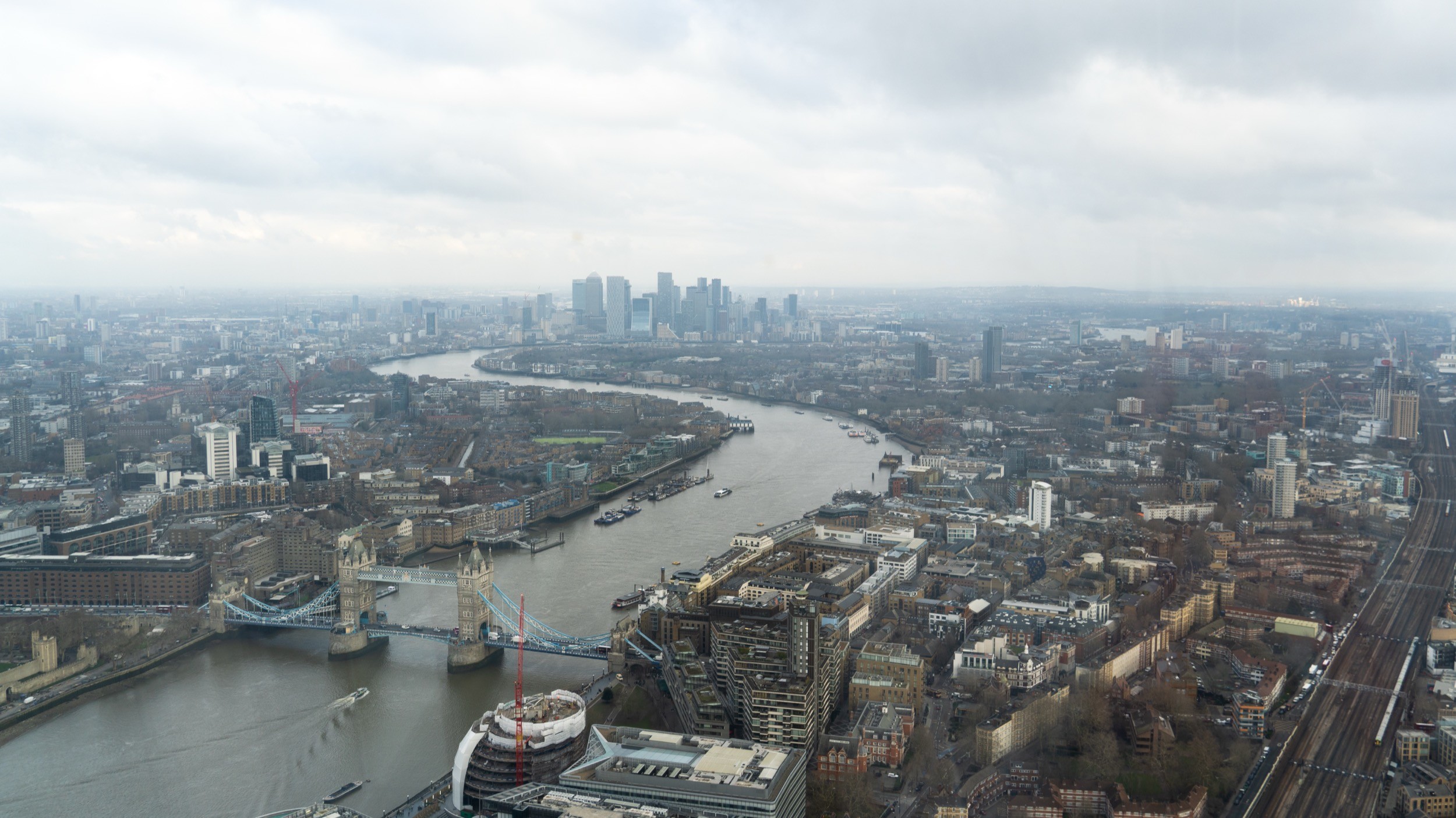 Two classic volkswagen beetles, one green, one cream.
