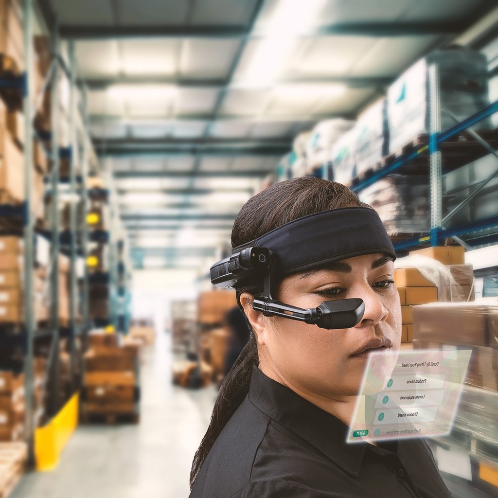 A photo of a warehouse worker wearing a RealWear headset