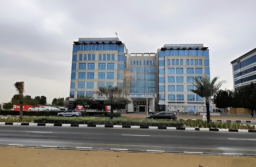 Street-side view of a modern commercial complex, perfect for real estate clients looking for office locations.