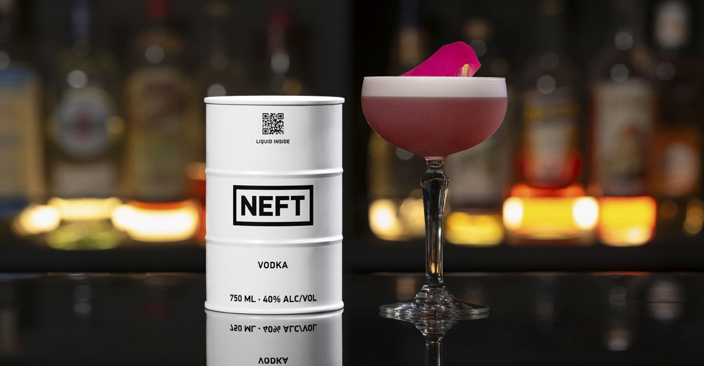 A NEFT Barrel and a glass of Rose Orchard on a bar counter.