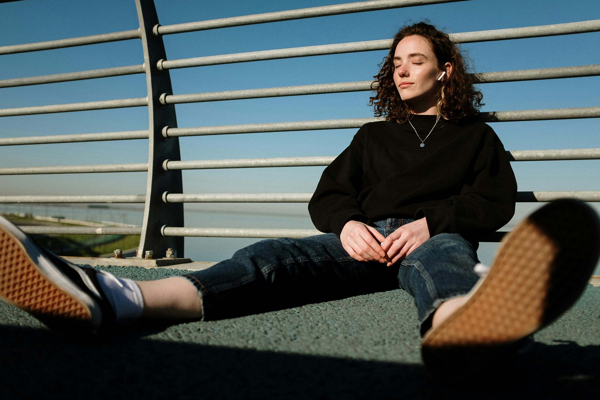 Girl sitting on a bridge