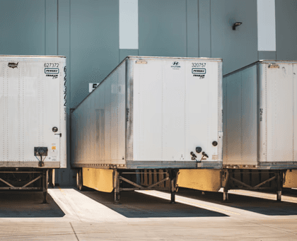 A row of semi trucks parked next to each other