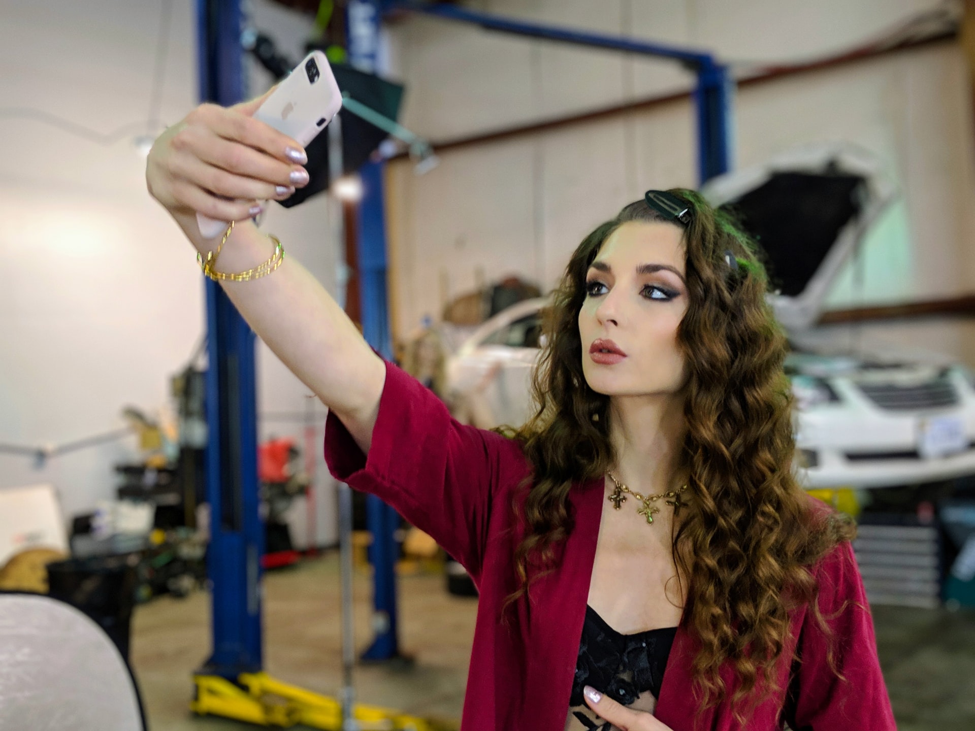 A beautiful, long-haired woman taking an Instagram selfie