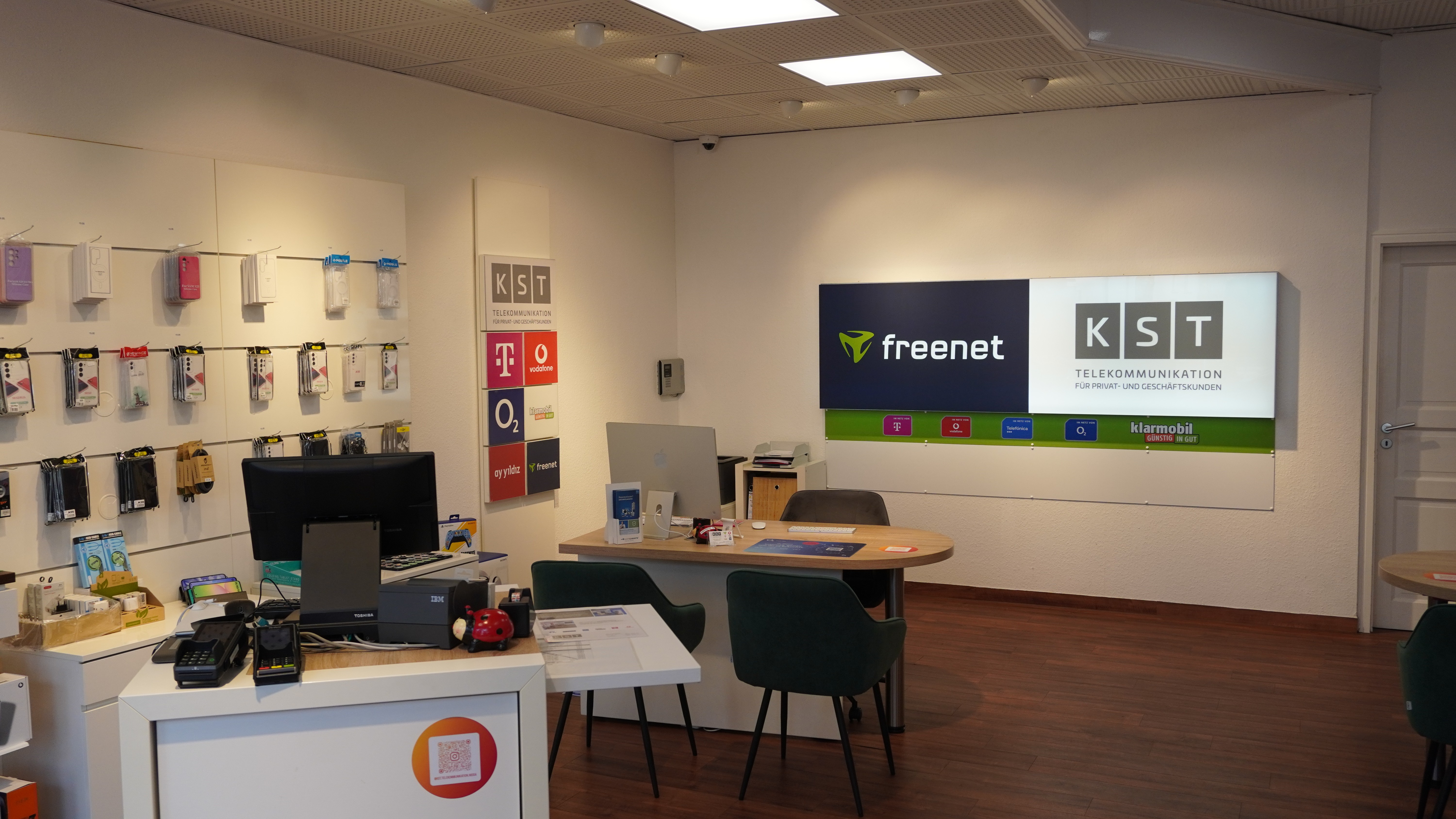 Modern living room with vertical garden, yellow sofas, and stylish coffee tables.