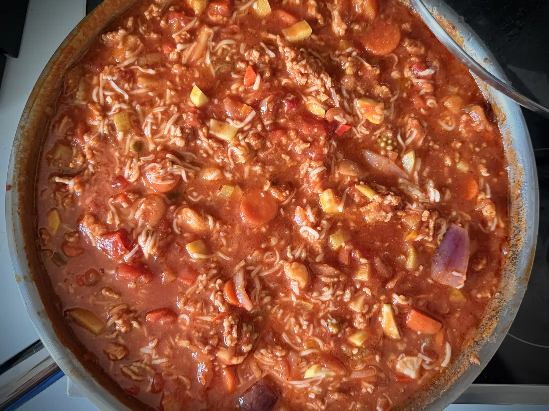 Een pan met een kleurrijk gerecht in rode saus.