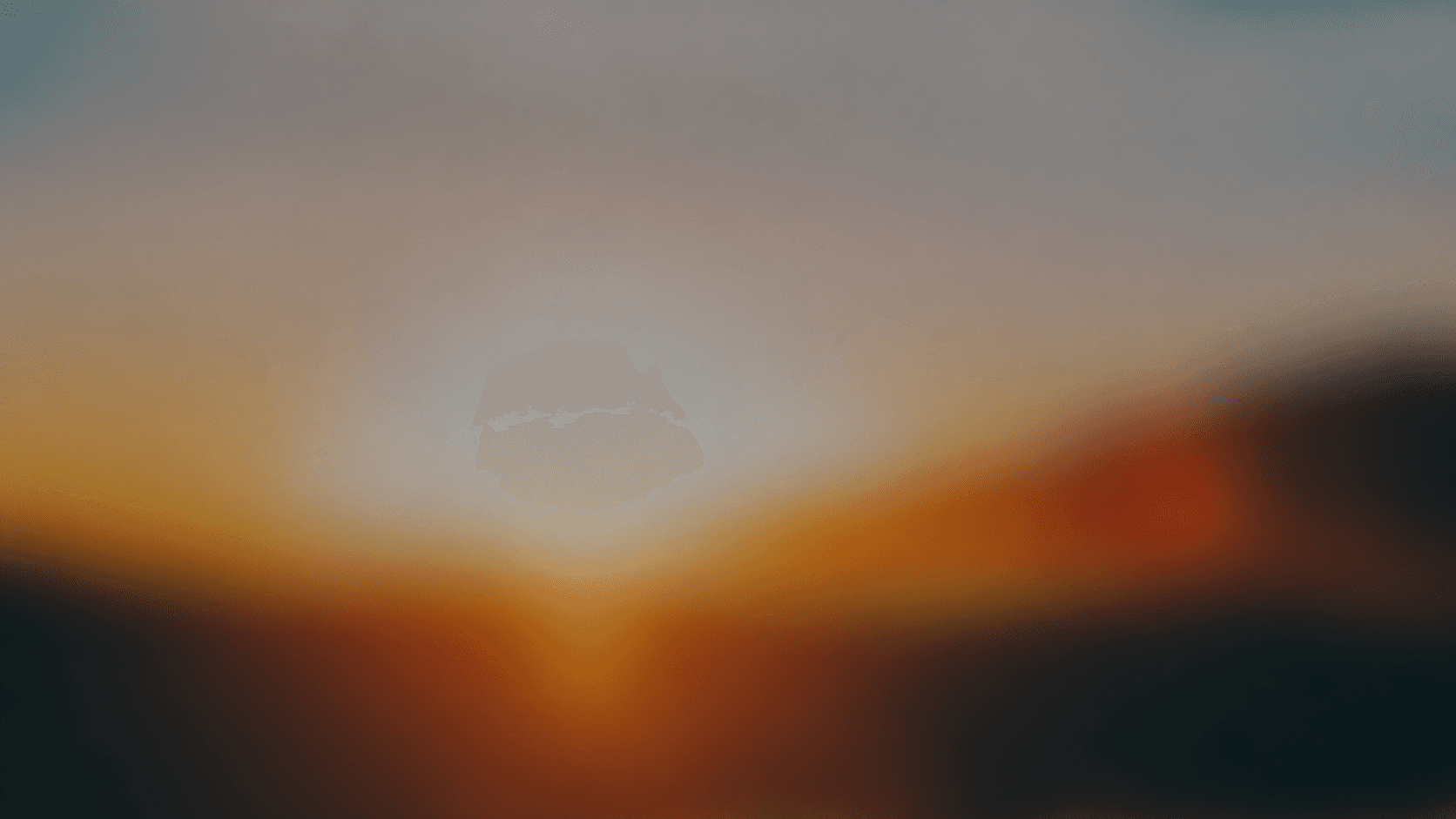 Abstract blurred field of warm orange, grey and deep teal light