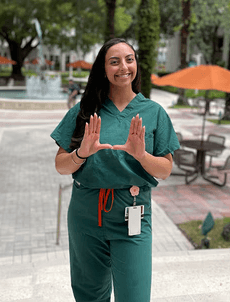 man in white bathrobe holding clear drinking glass with yellow liquid