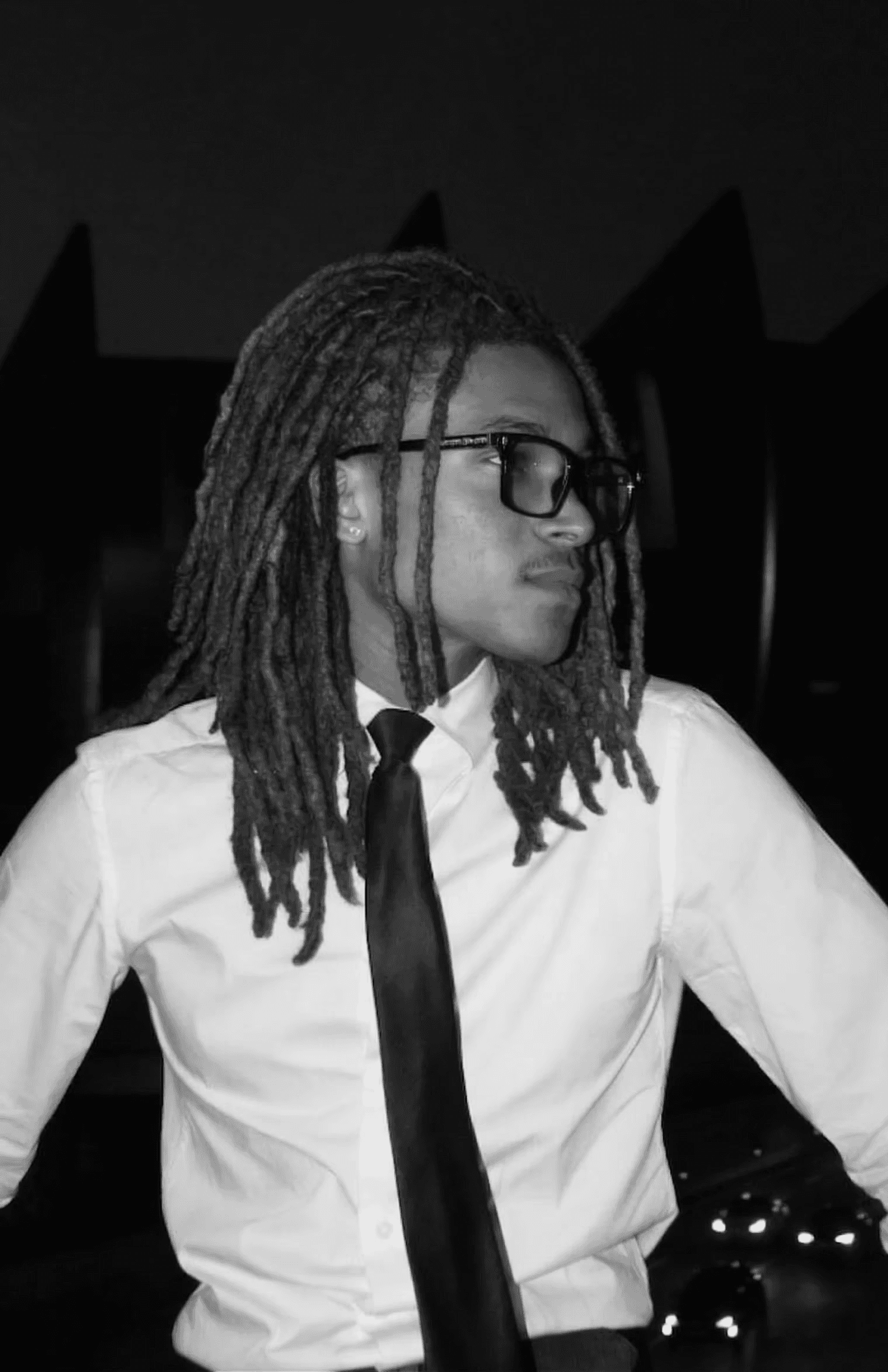 Young man in a white shirt witprint, against a black background