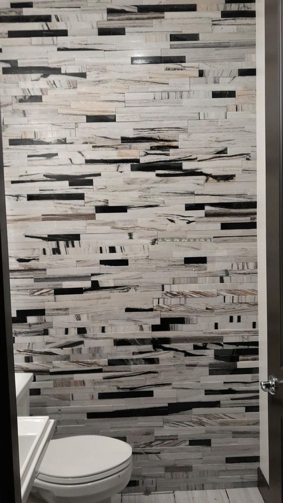 Stylish kitchen featuring a textured, multicolored linear tile backsplash with a unique pattern.