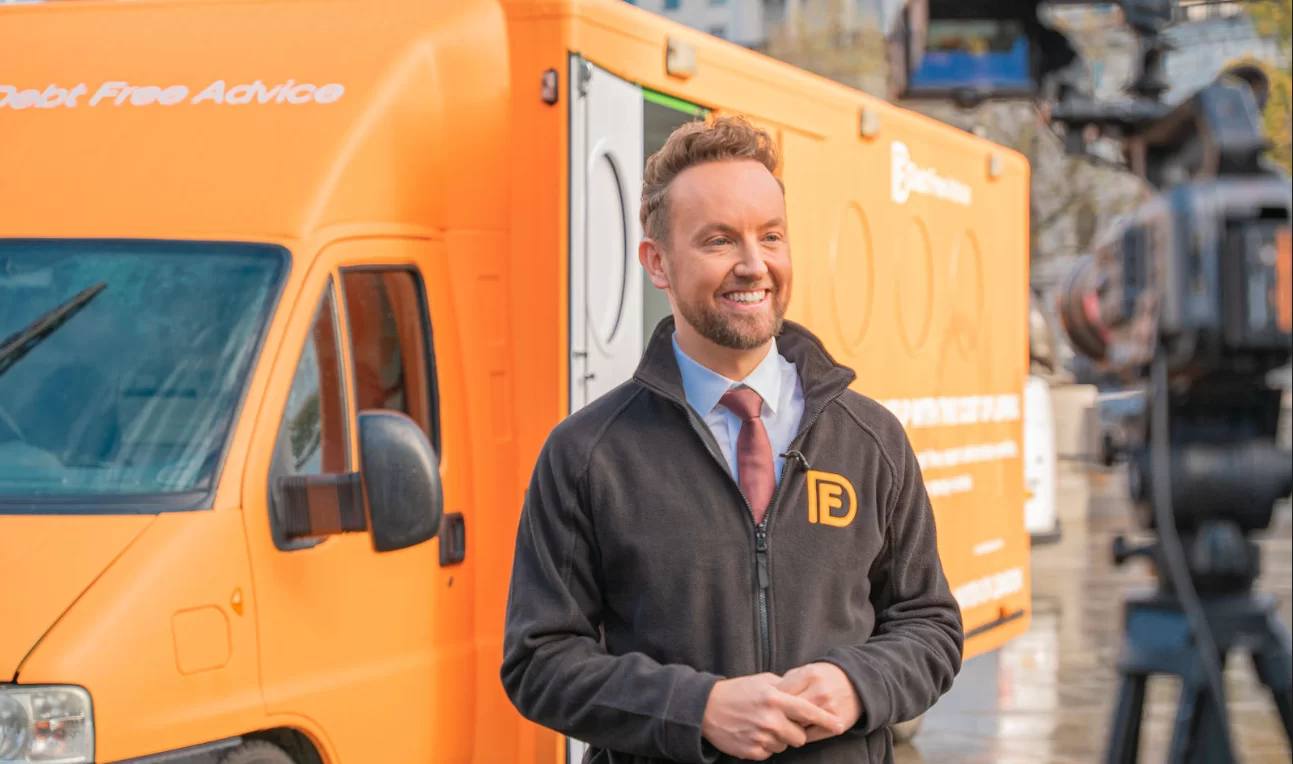 Matt Dronfield stood in front of orange van