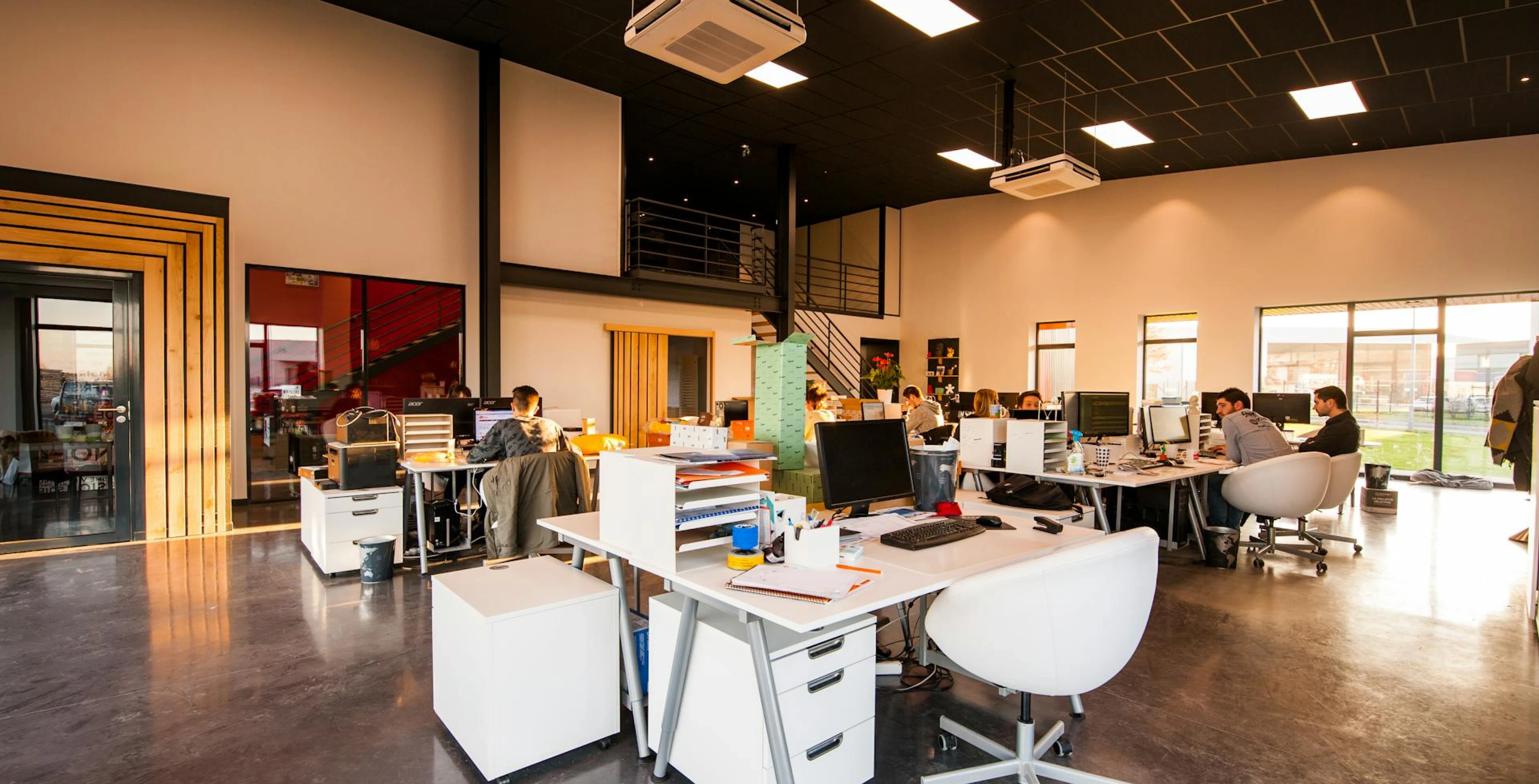 An office setting with workspaces in the middle of the room