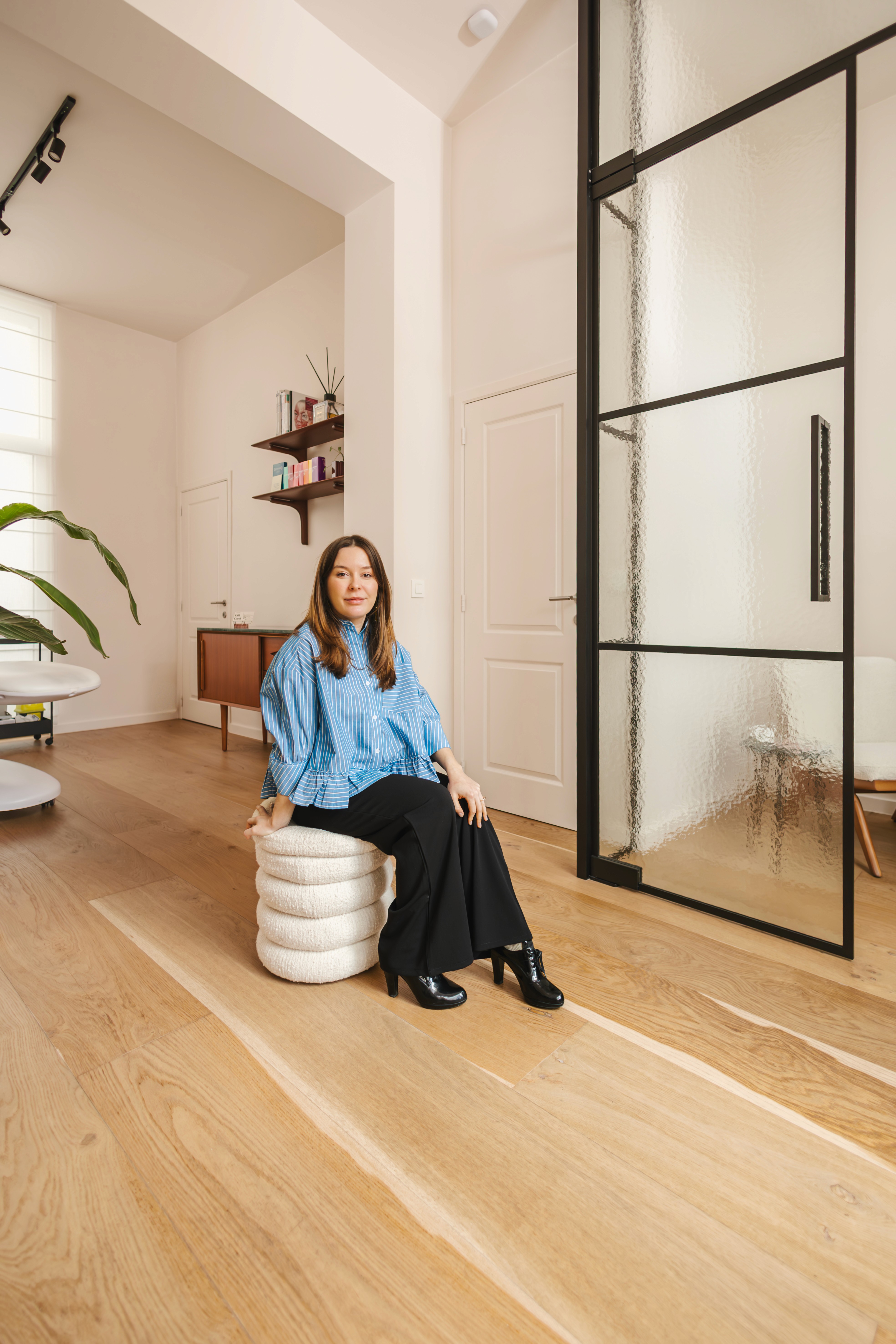 Dr. Louise Cuveele sitting in her home-based practice.
