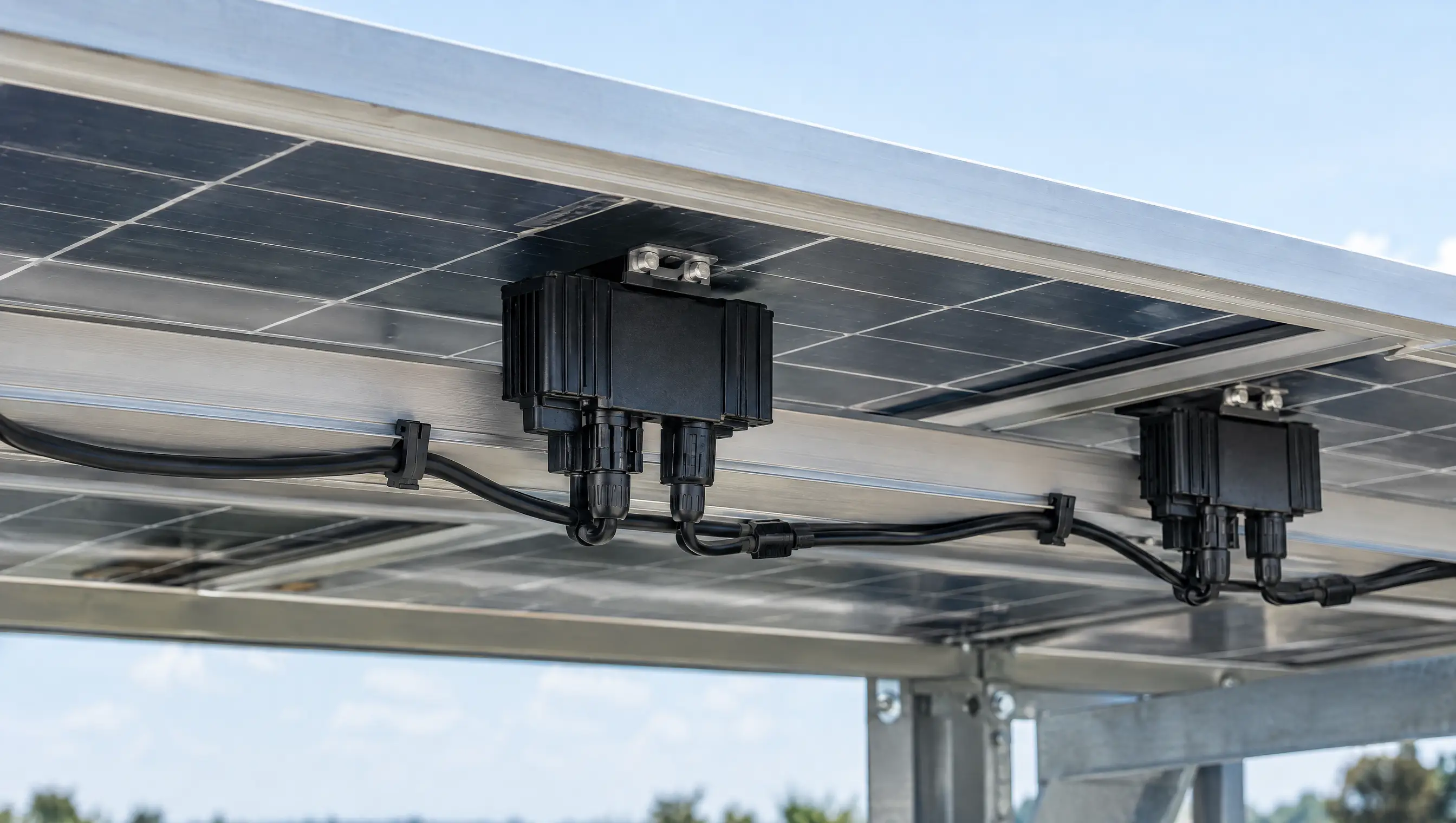 Power optimisers fitted beneath solar panels on the mounting rails
