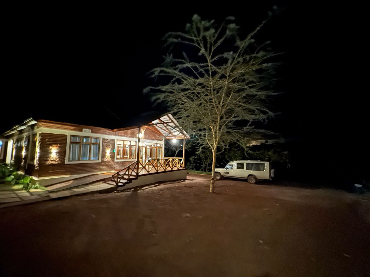 Traditional Arabic setup with chairs and lanterns in the desert sands of AlUla during sunrise.