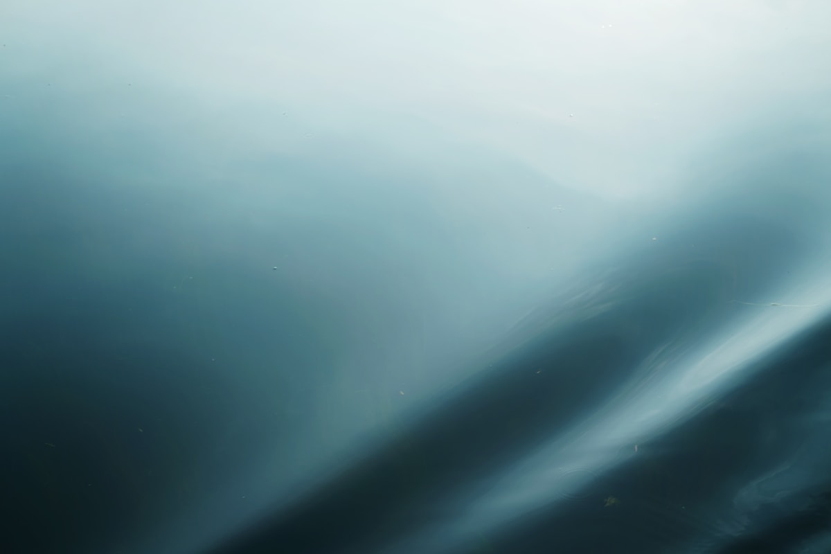 Abstract blue gradient background with diagonal light streaks