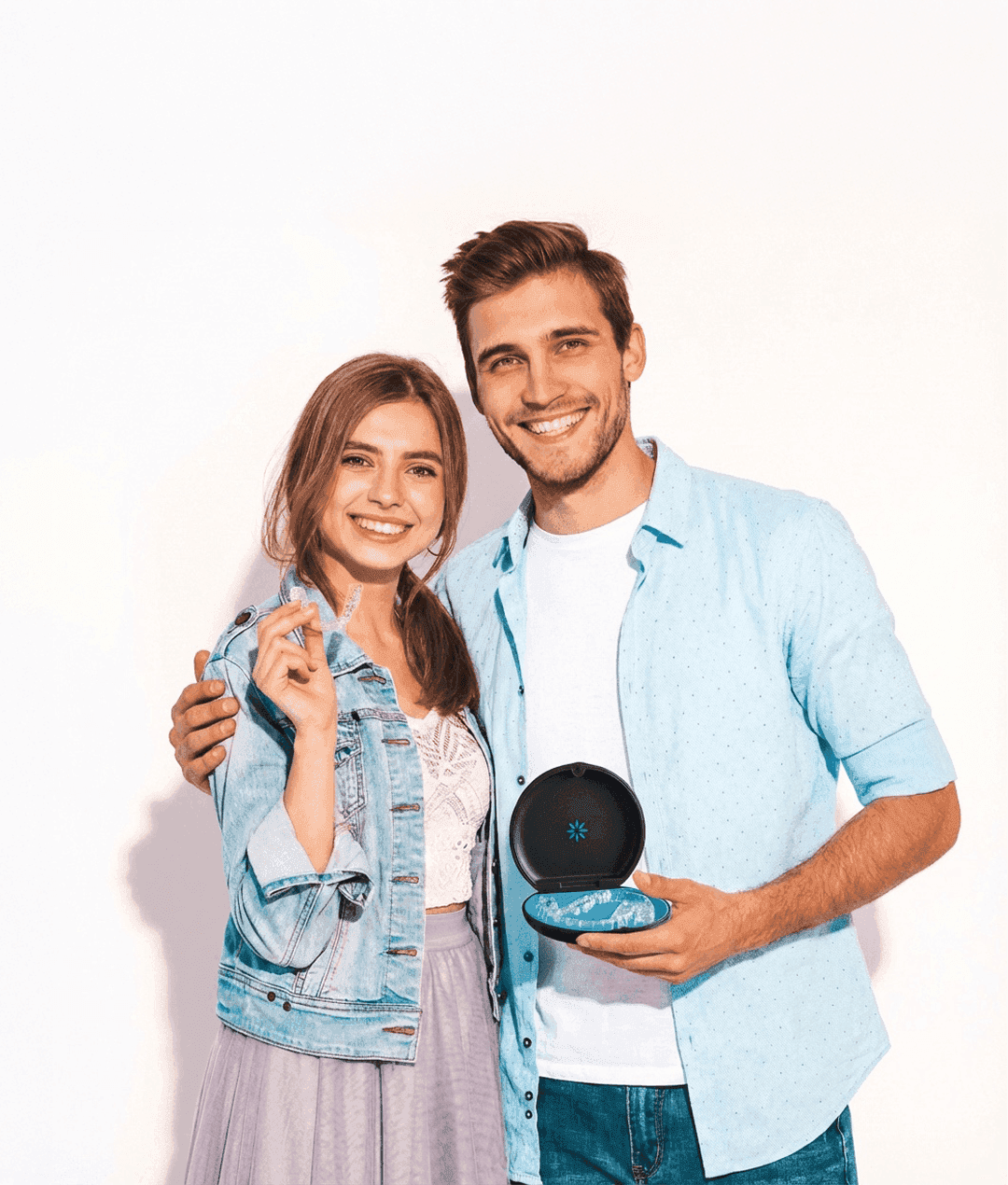 A woman smiles and holds invisalign clear aligners with a case, showcasing a certified invisalign provider at Bella Medical Centre