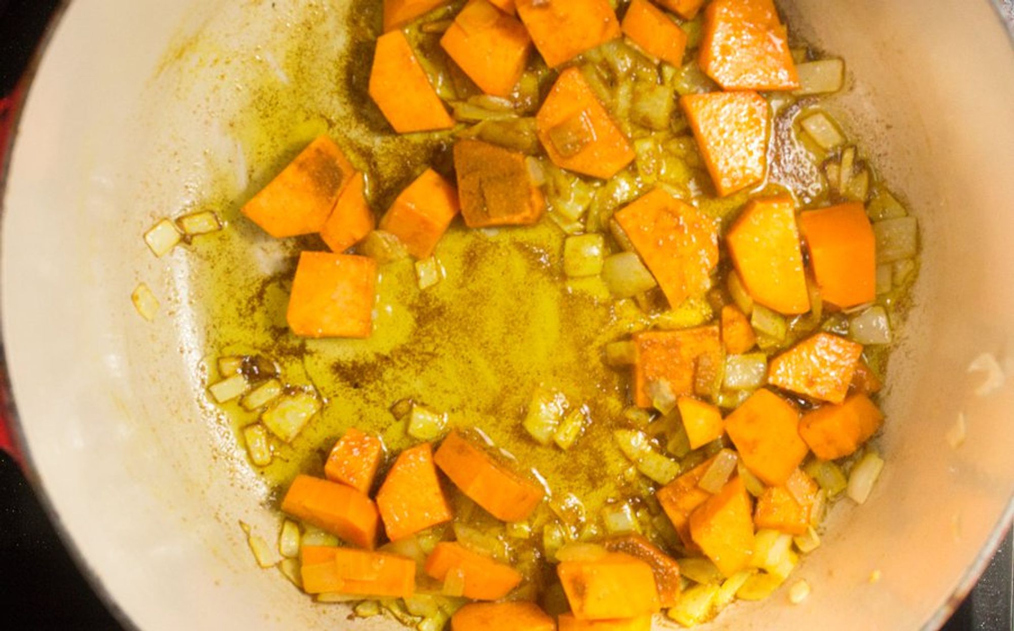 sweet potatoes with curry powder in a pan