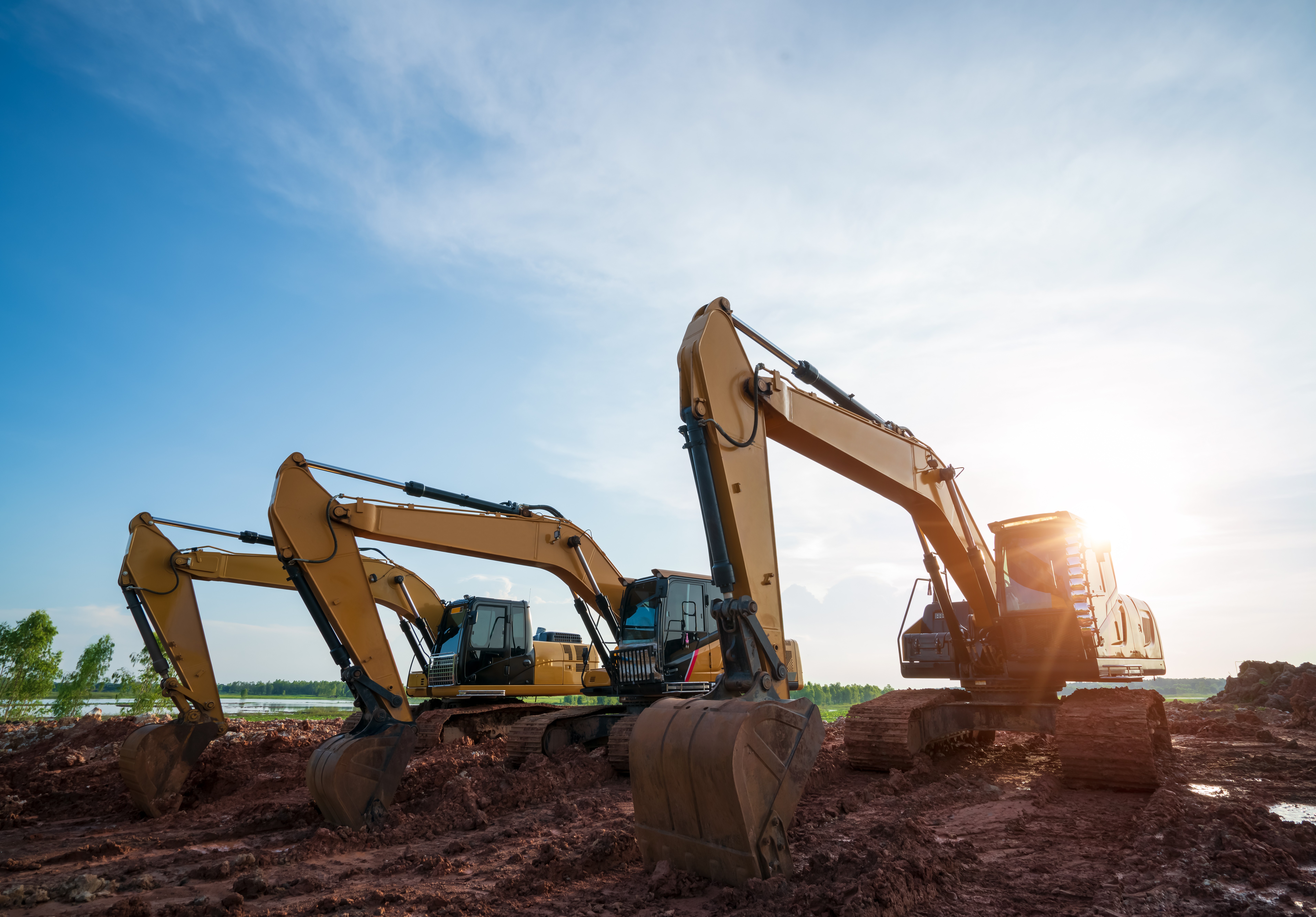 Hitachi excavator digging into dark rock in a quarry