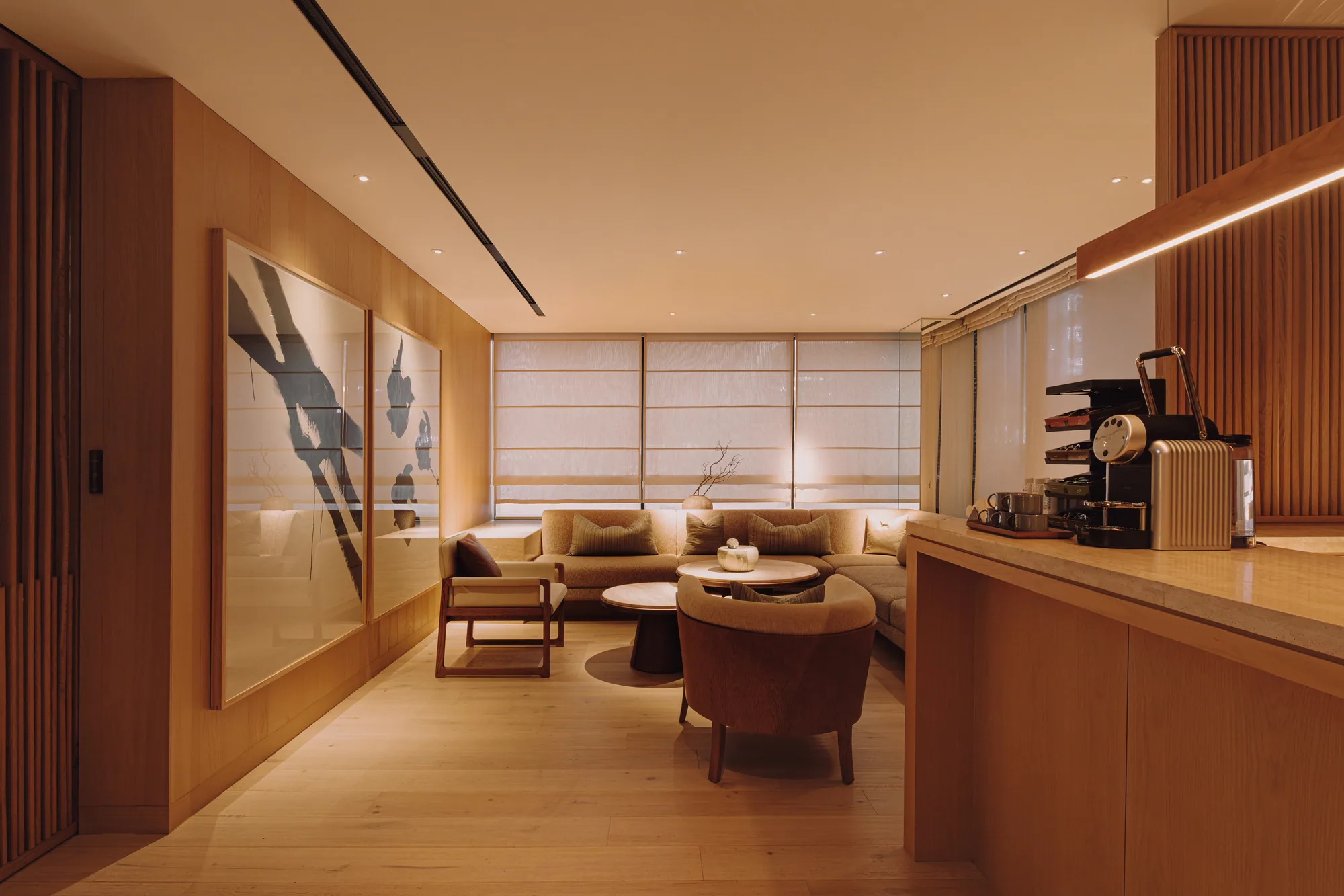 The concierge counter in timber and open shelving on the PLAYA ground-floor lounge