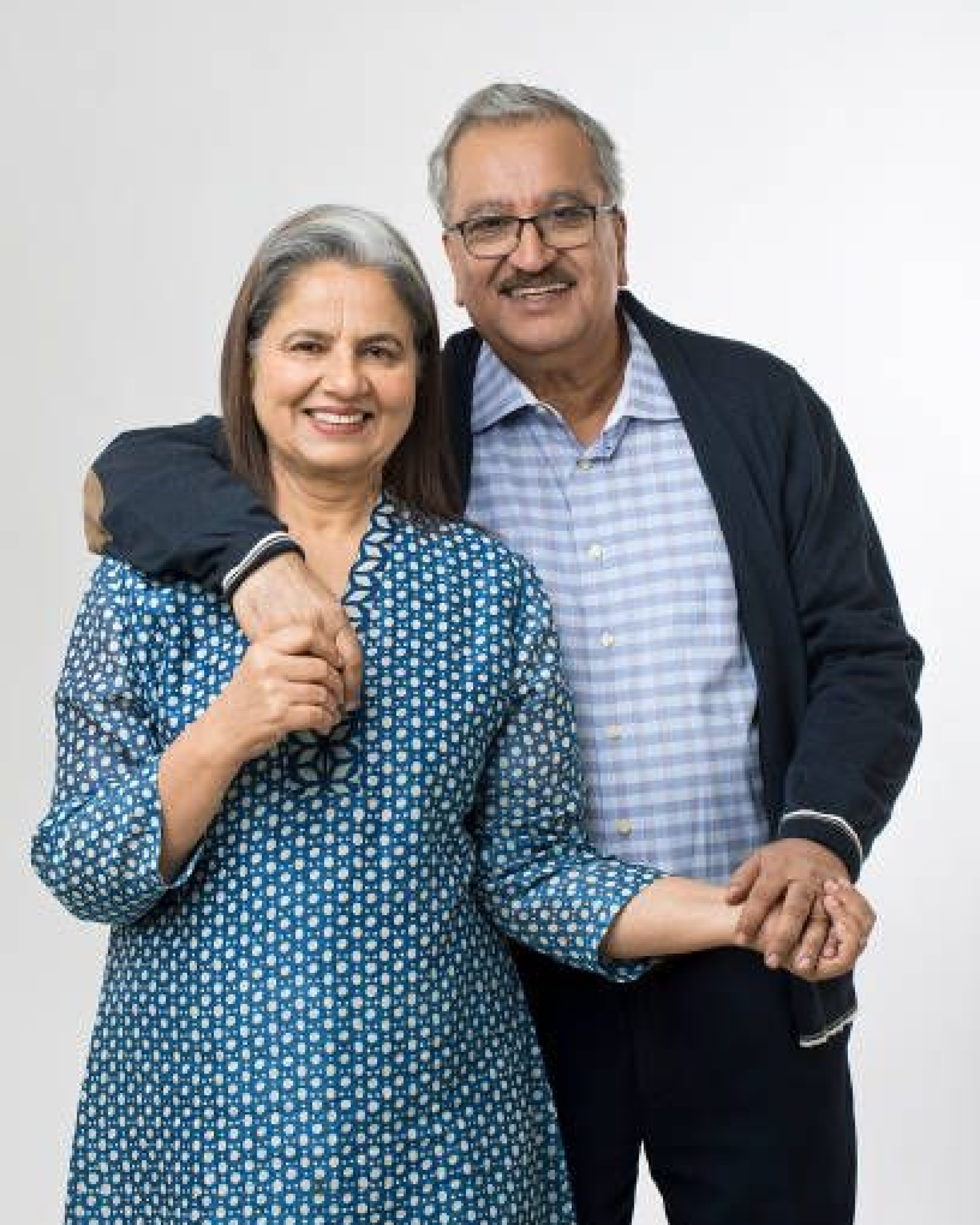 Smiling senior couple standing together, looking relaxed and confident.