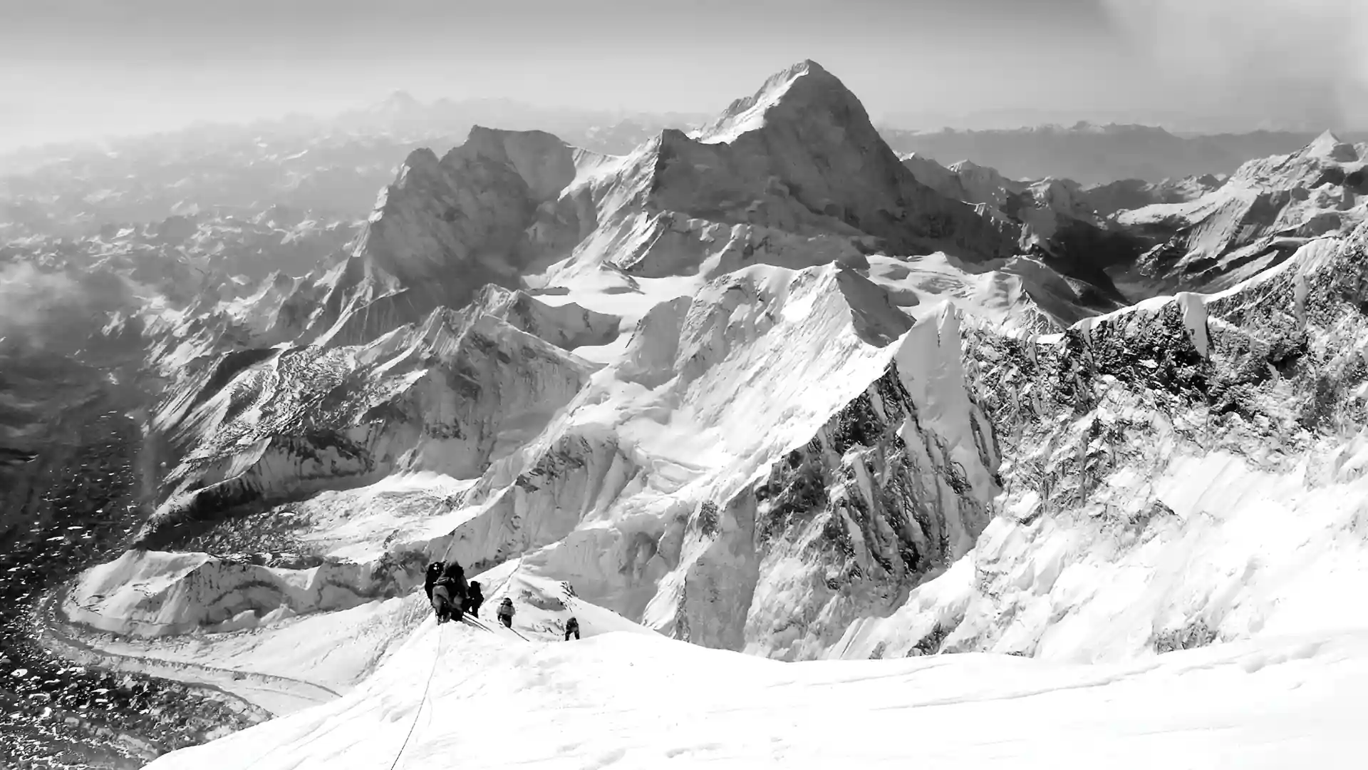 Sherpas guiding climbers up a mountain