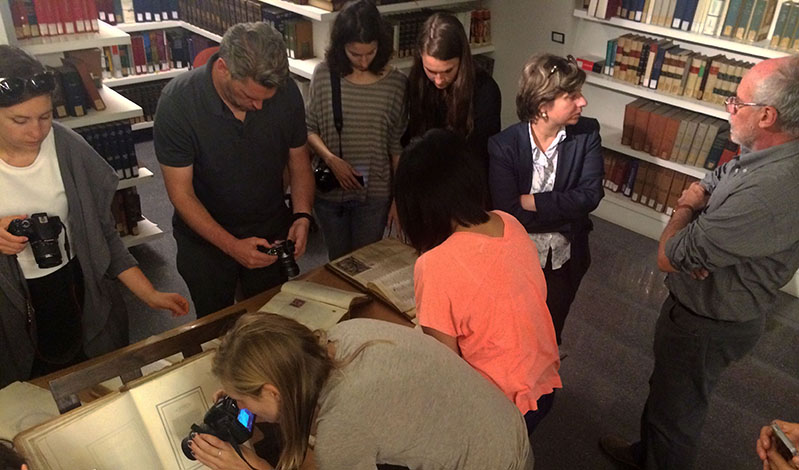 students taking pictures of old books