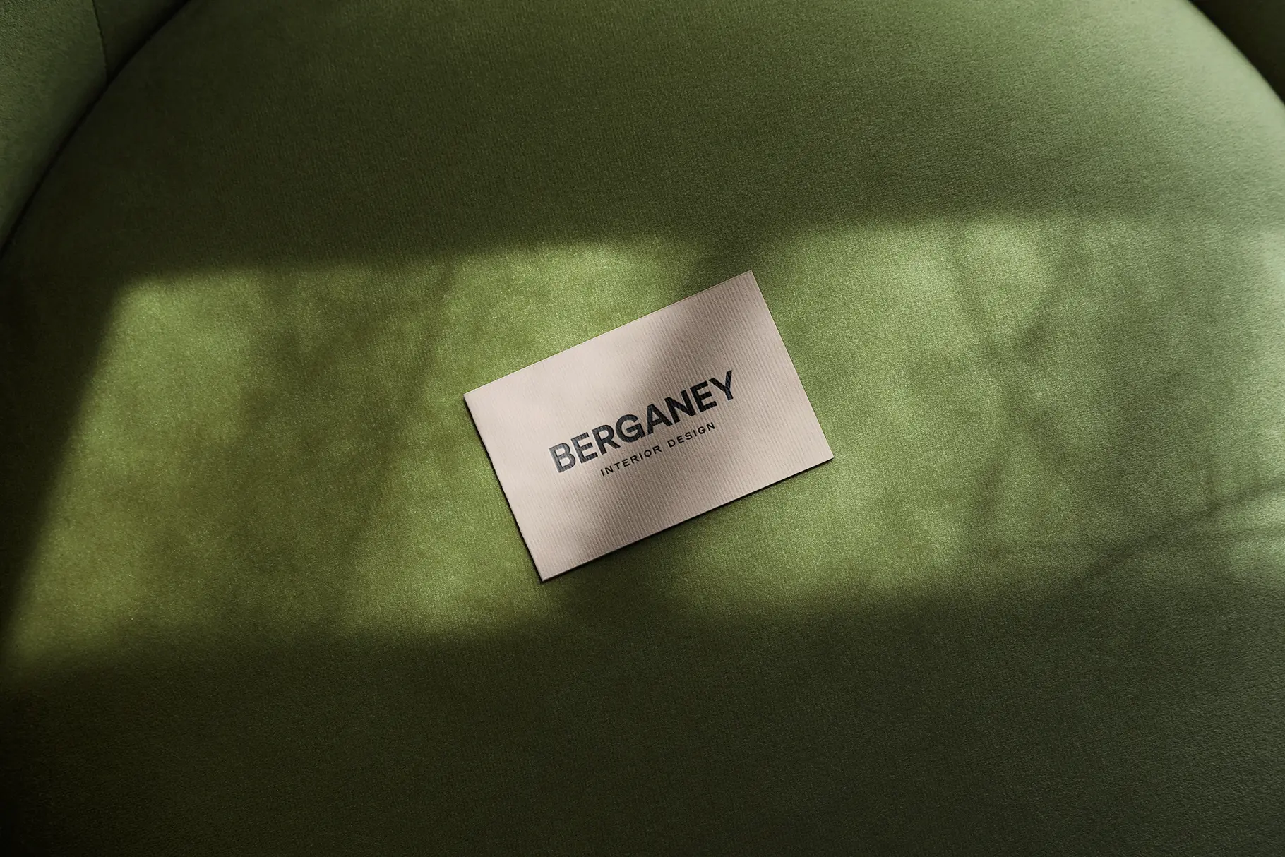 Minimal business card mockup on textured surface with natural sunlight shadows and premium branding presentation.