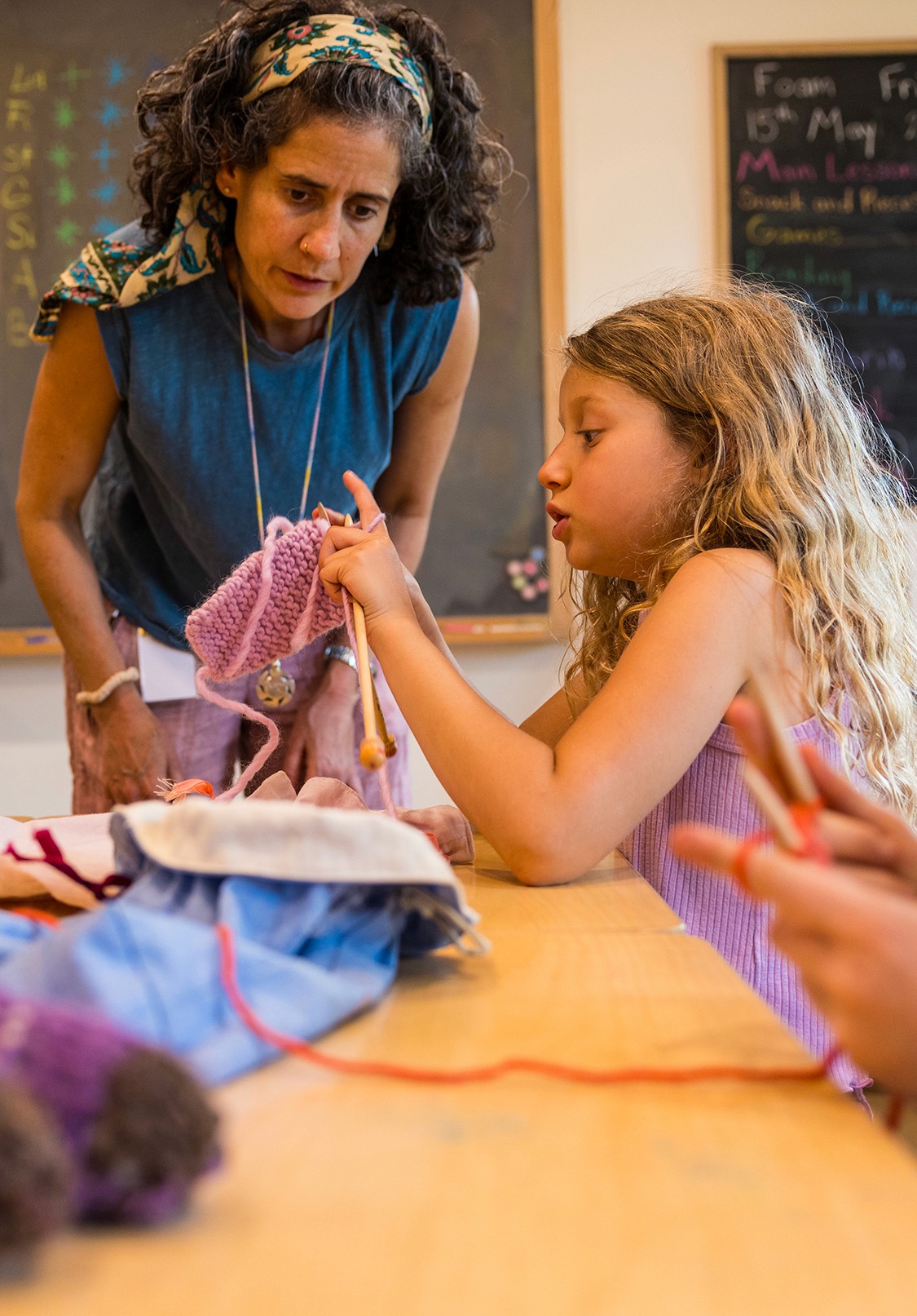 Elementary students creating art together in a bright classroom