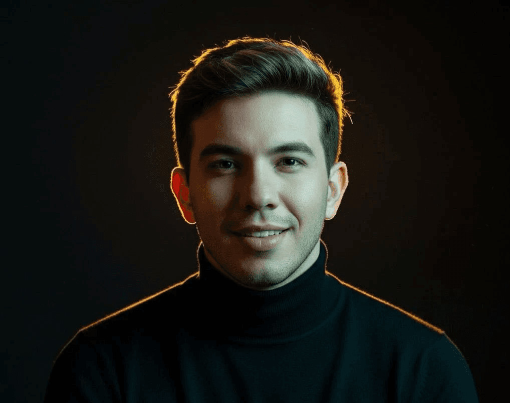 a man with a goatee smiles at the camera