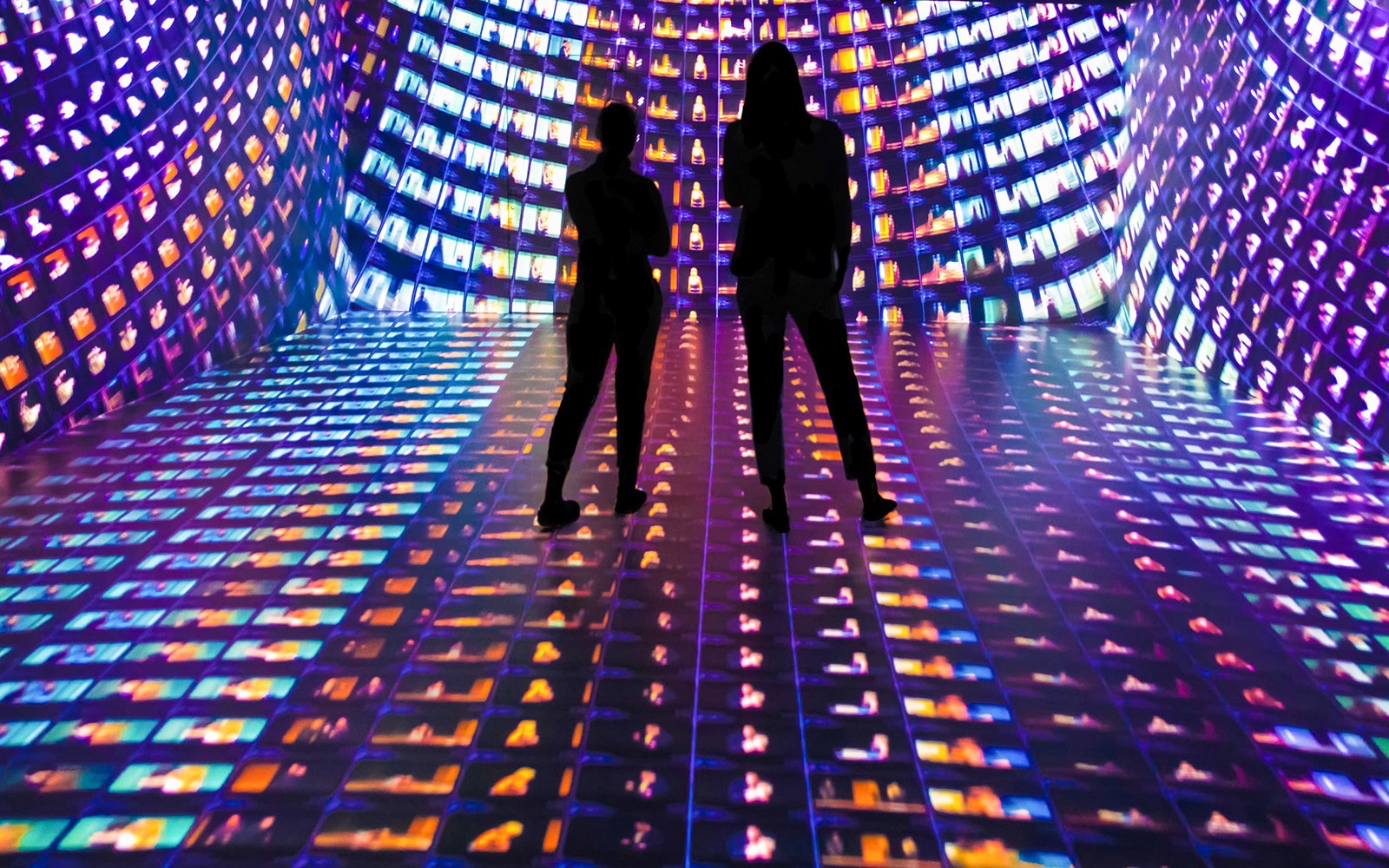 Visitors in an immersive digital art installation at Mythos Mozart exhibit.