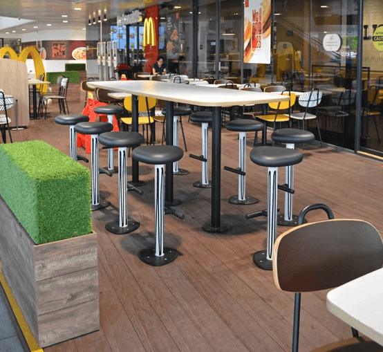 brown wooden chairs and table near glass window