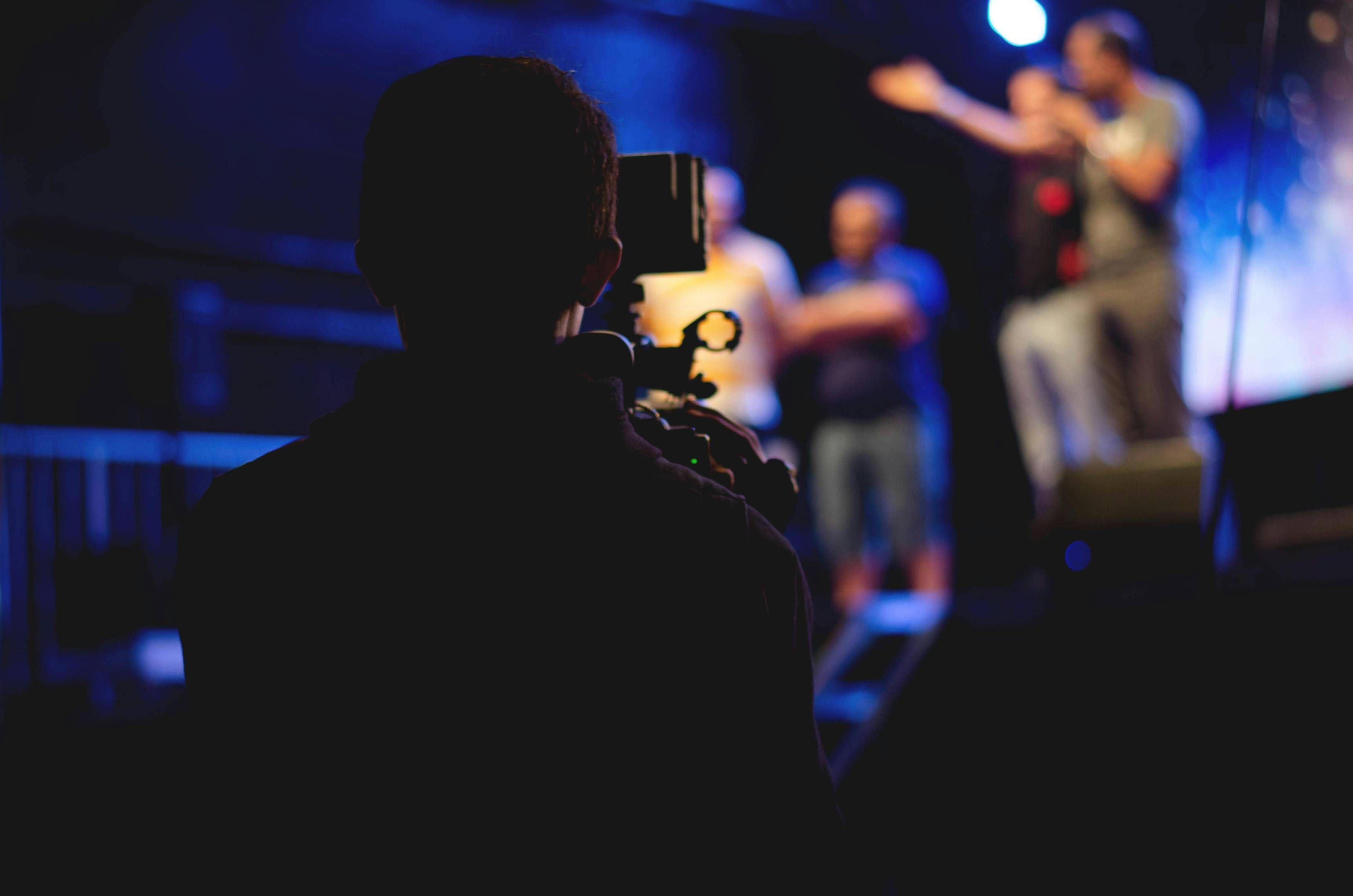 Videographer filming on stage during a live event video production